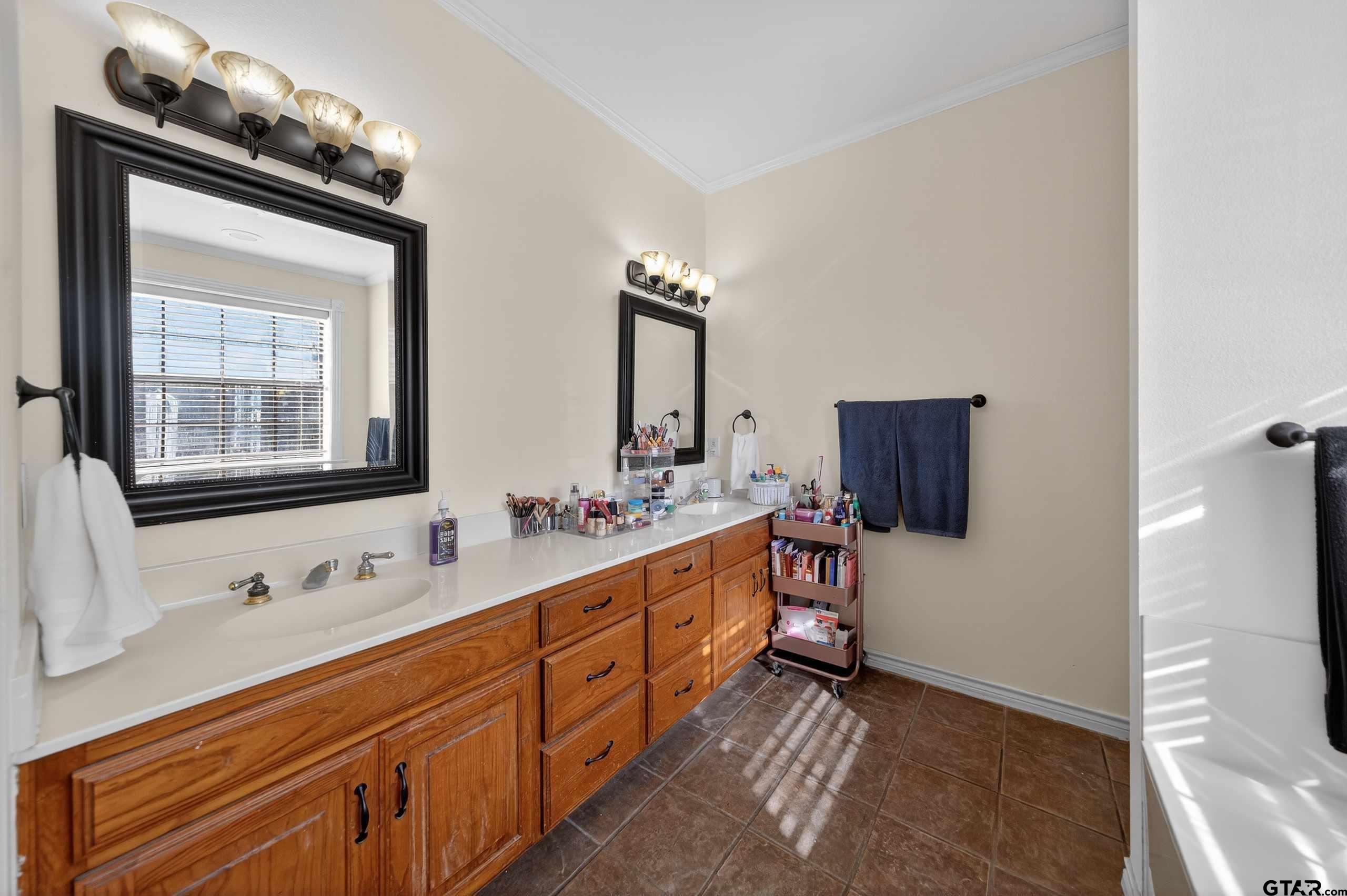 781 Highway 19 Edgewood, TX 75117 - Photo 35 of 48 a bathroom with a sink double vanity and a mirror