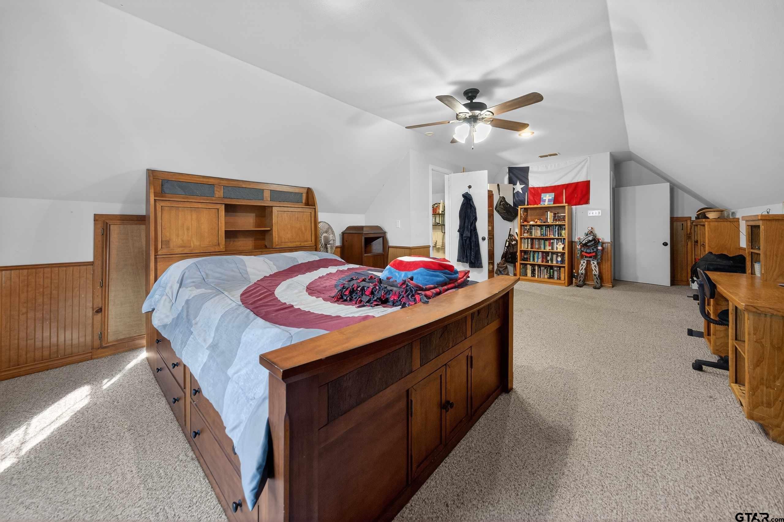 781 Highway 19 Edgewood, TX 75117 - Photo 39 of 48 a bedroom with a bed and a chandelier