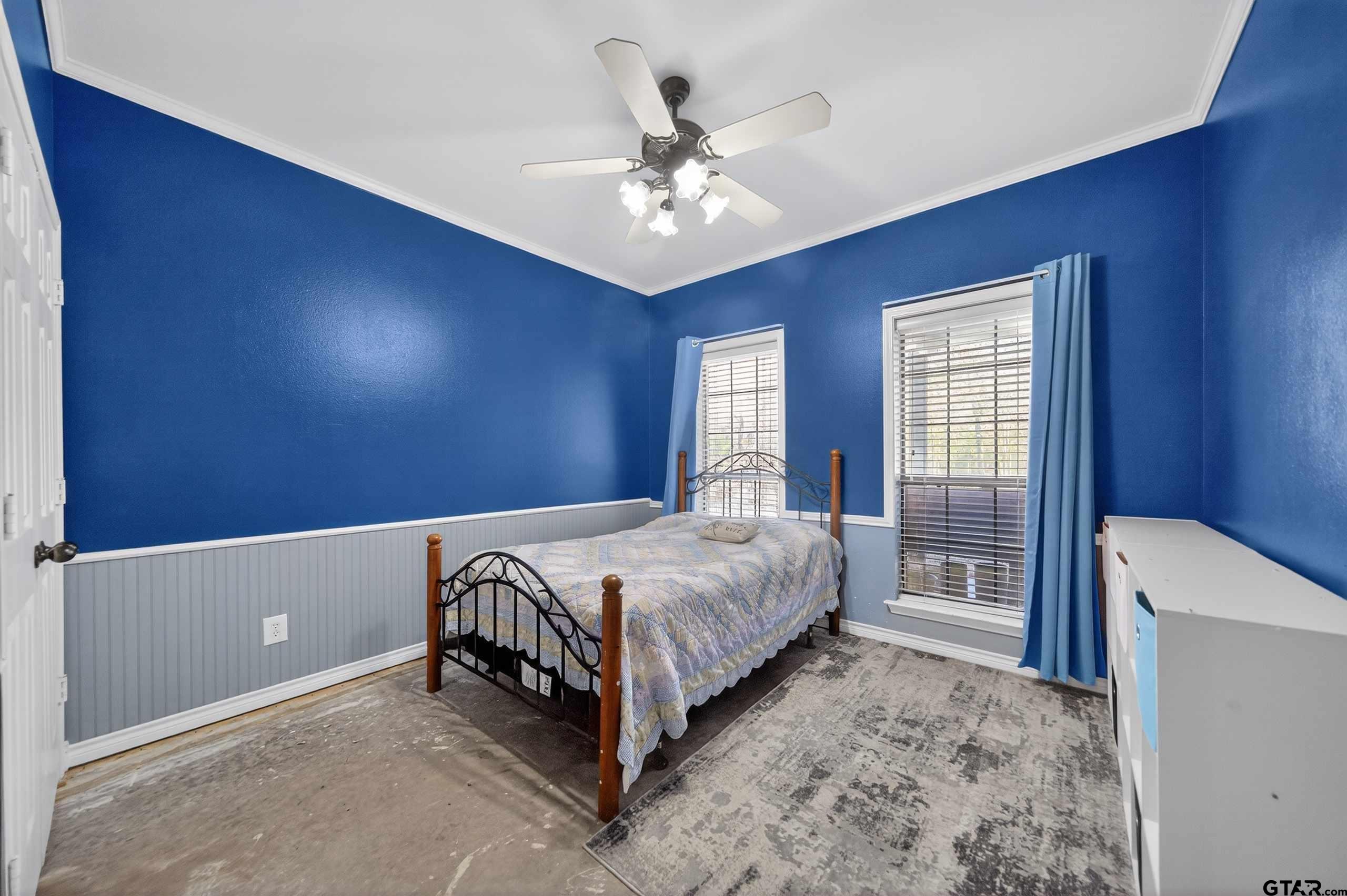 781 Highway 19 Edgewood, TX 75117 - Photo 41 of 48 a spacious bedroom with a bed and a chandelier