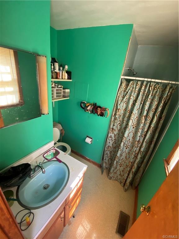 241 Nottoway Falls Road Kenbridge, VA 23944 - Photo 17 of 29 a bathroom with a sink mirror and toilet