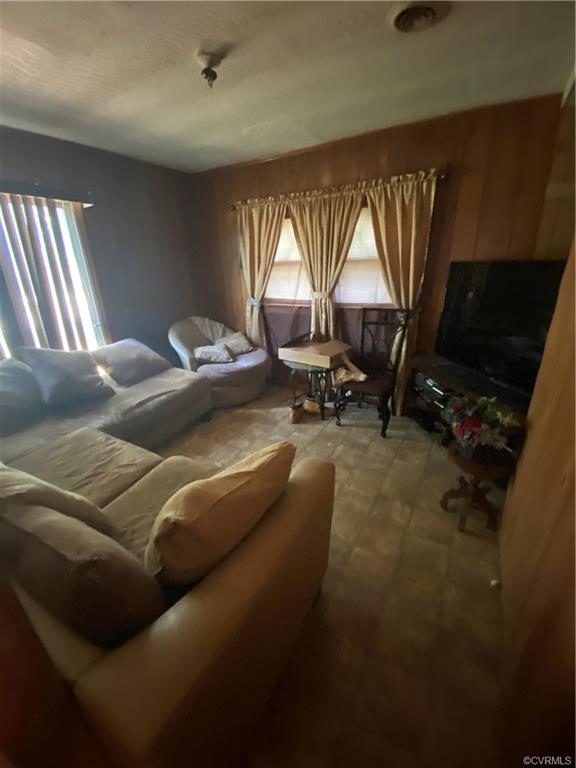 241 Nottoway Falls Road Kenbridge, VA 23944 - Photo 24 of 29 a living room with furniture a flat screen tv and a window