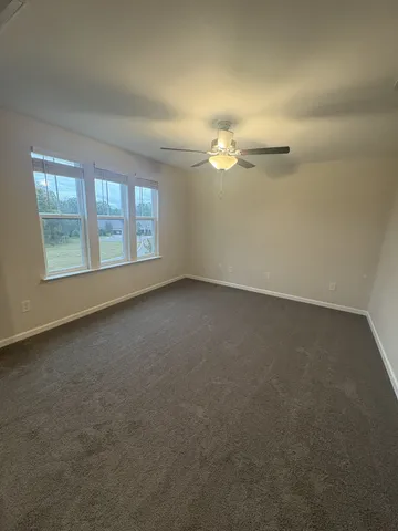 an empty room with a empty space and windows