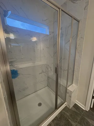 a bathroom with a glass shower door