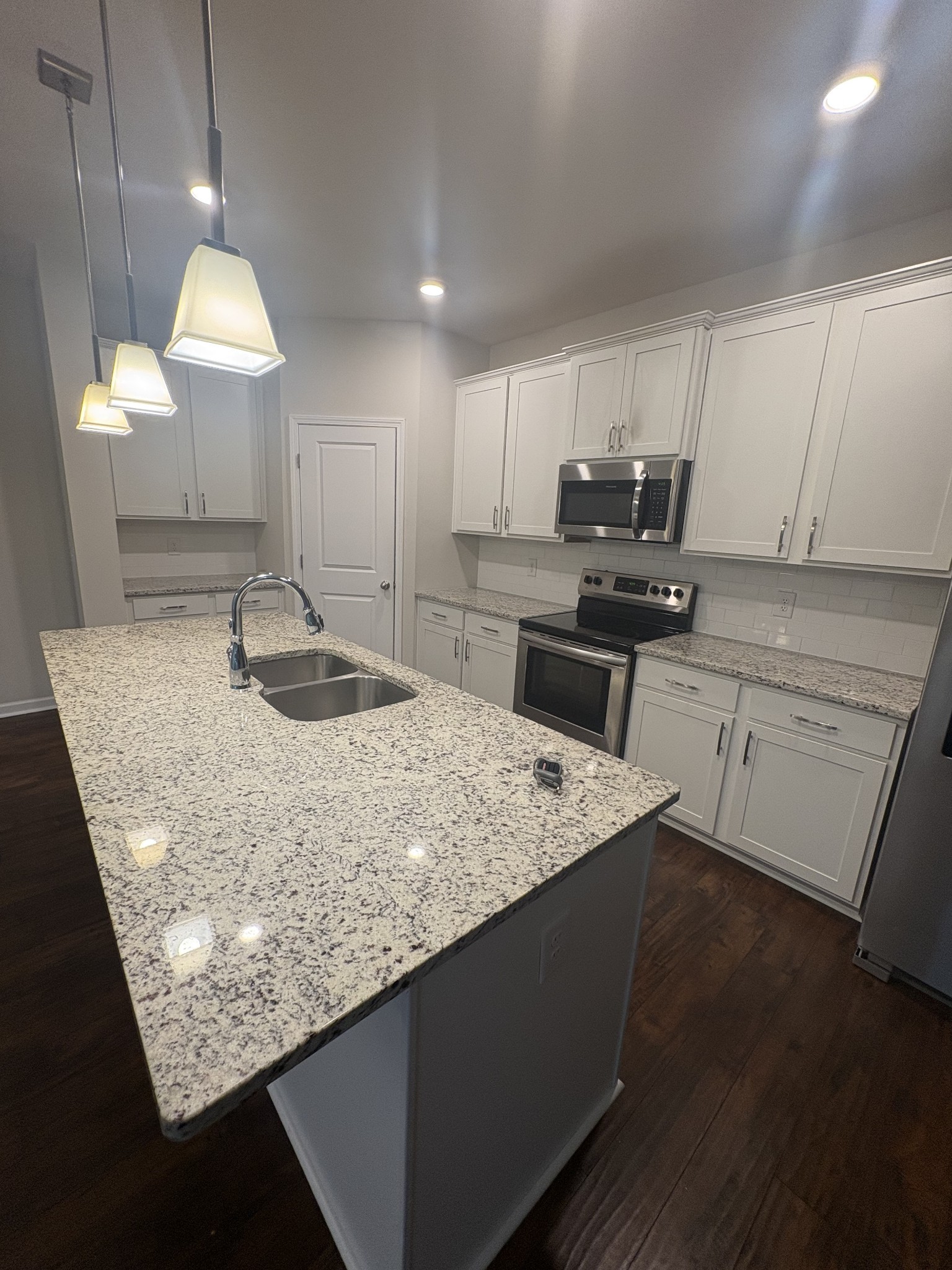 422 Butler Road Mount Juliet, TN 37122 - Photo 9 of 28 a kitchen with kitchen island granite countertop a sink a counter top space appliances and cabinets