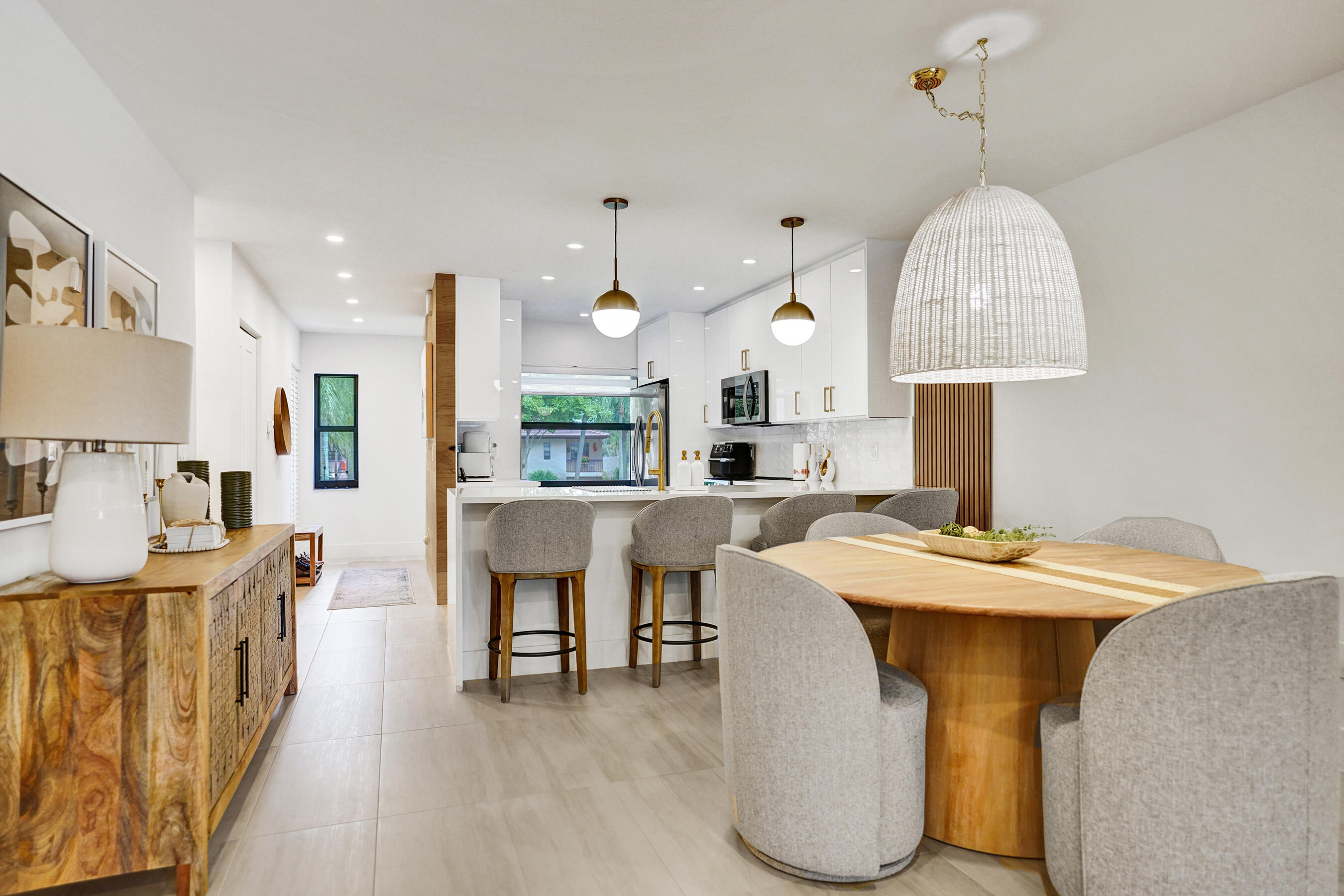 9293 Vista Del Lago, Unit 15F Boca Raton, FL 33428 - Photo 13 of 42 a room with stainless steel appliances kitchen island a table chairs in it and kitchen view