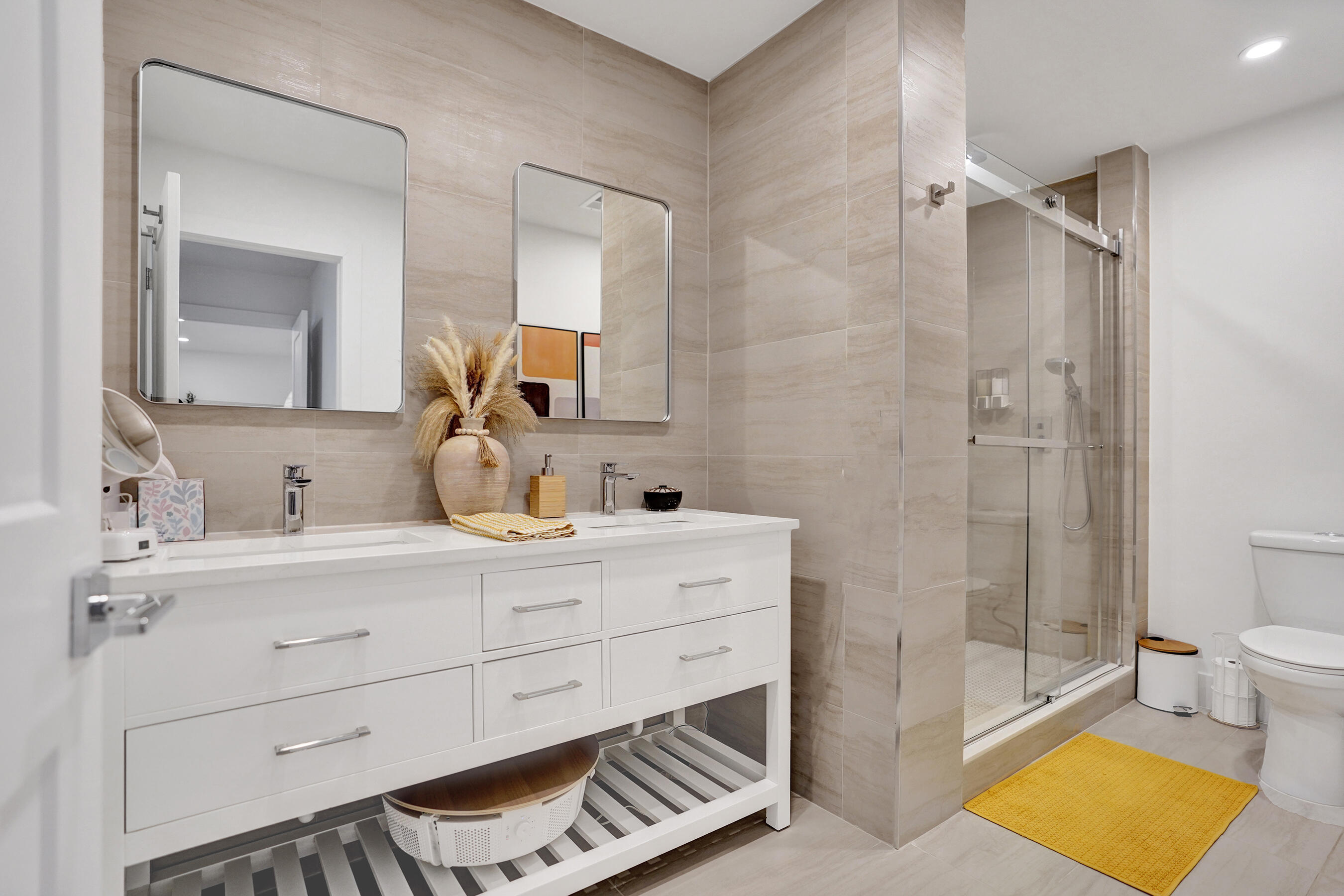 9293 Vista Del Lago, Unit 15F Boca Raton, FL 33428 - Photo 15 of 42 a spacious bathroom with a double vanity sink toilet and shower