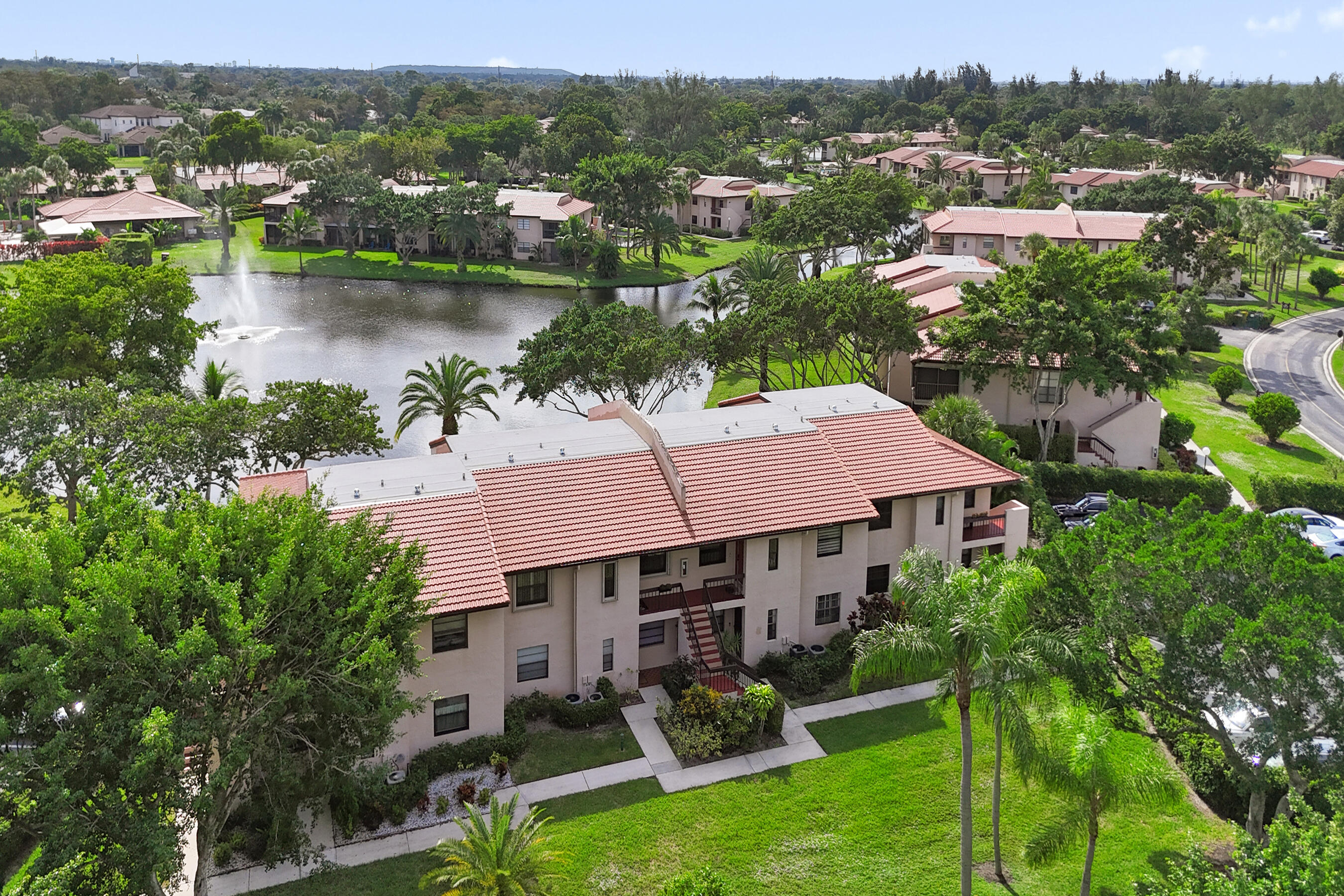 9293 Vista Del Lago, Unit 15F Boca Raton, FL 33428 - Photo 27 of 42 a view of a house with garden and a patio