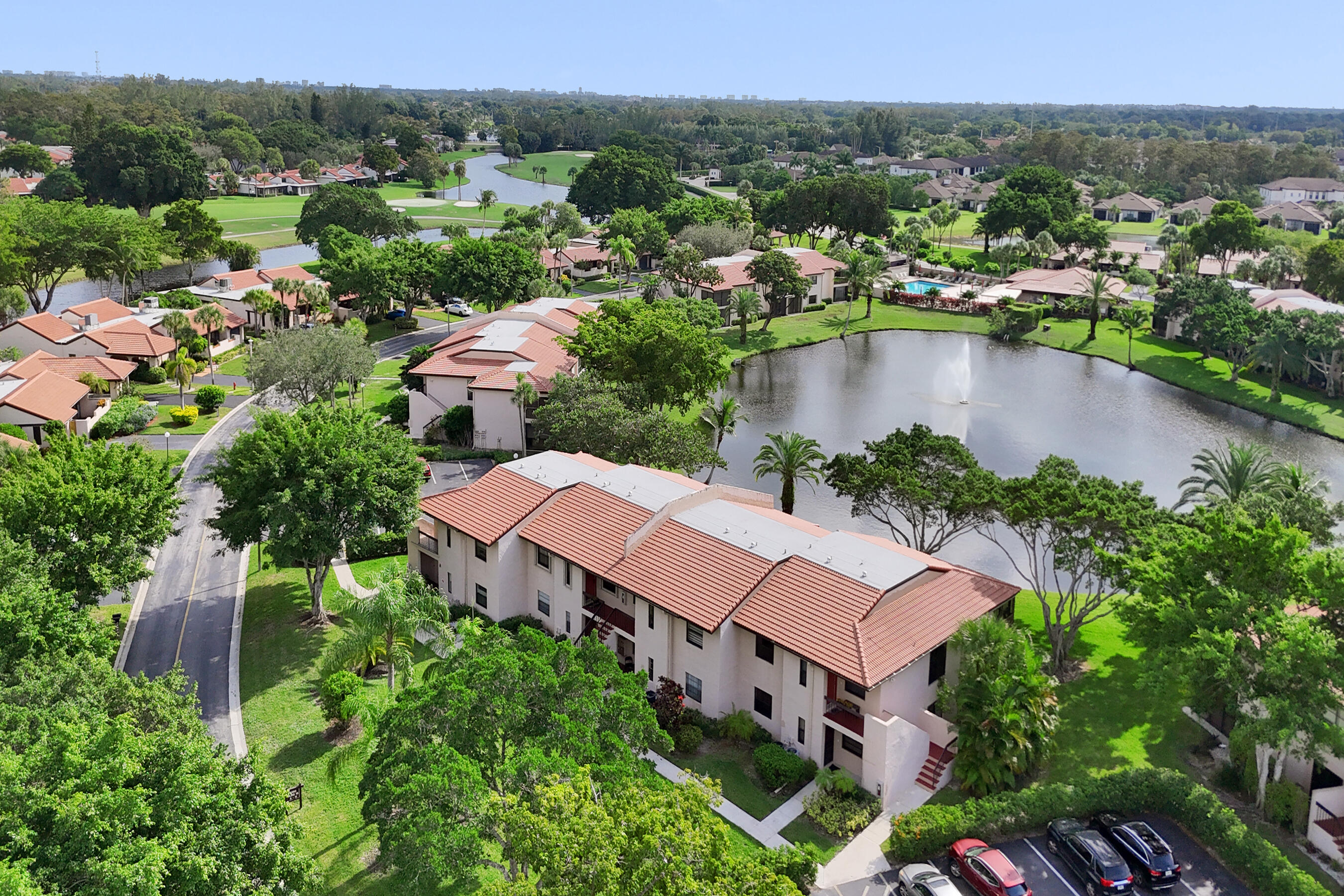 9293 Vista Del Lago, Unit 15F Boca Raton, FL 33428 - Photo 28 of 42 an aerial view of a houses with a yard and lake view