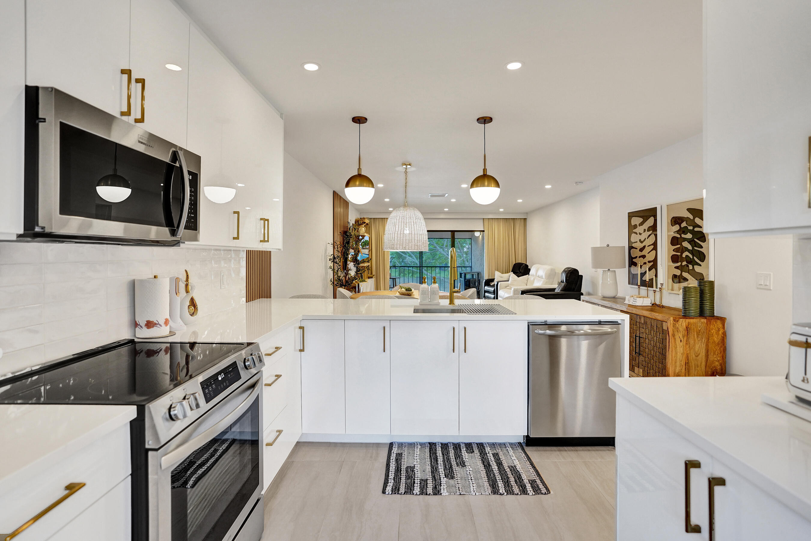 9293 Vista Del Lago, Unit 15F Boca Raton, FL 33428 - Photo 4 of 42 a kitchen with a sink stainless steel appliances and cabinets