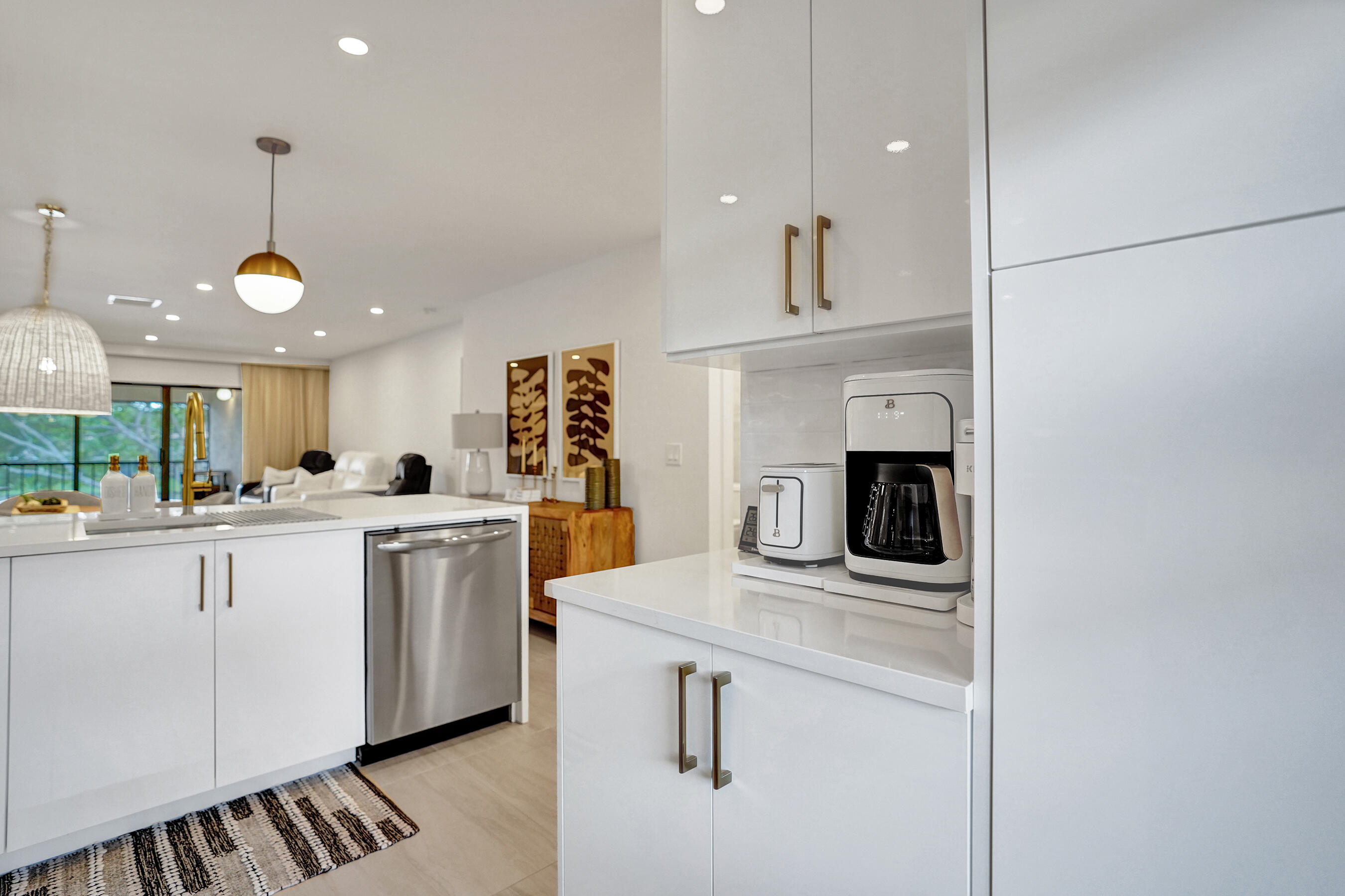 9293 Vista Del Lago, Unit 15F Boca Raton, FL 33428 - Photo 5 of 42 a kitchen with white cabinets and sink