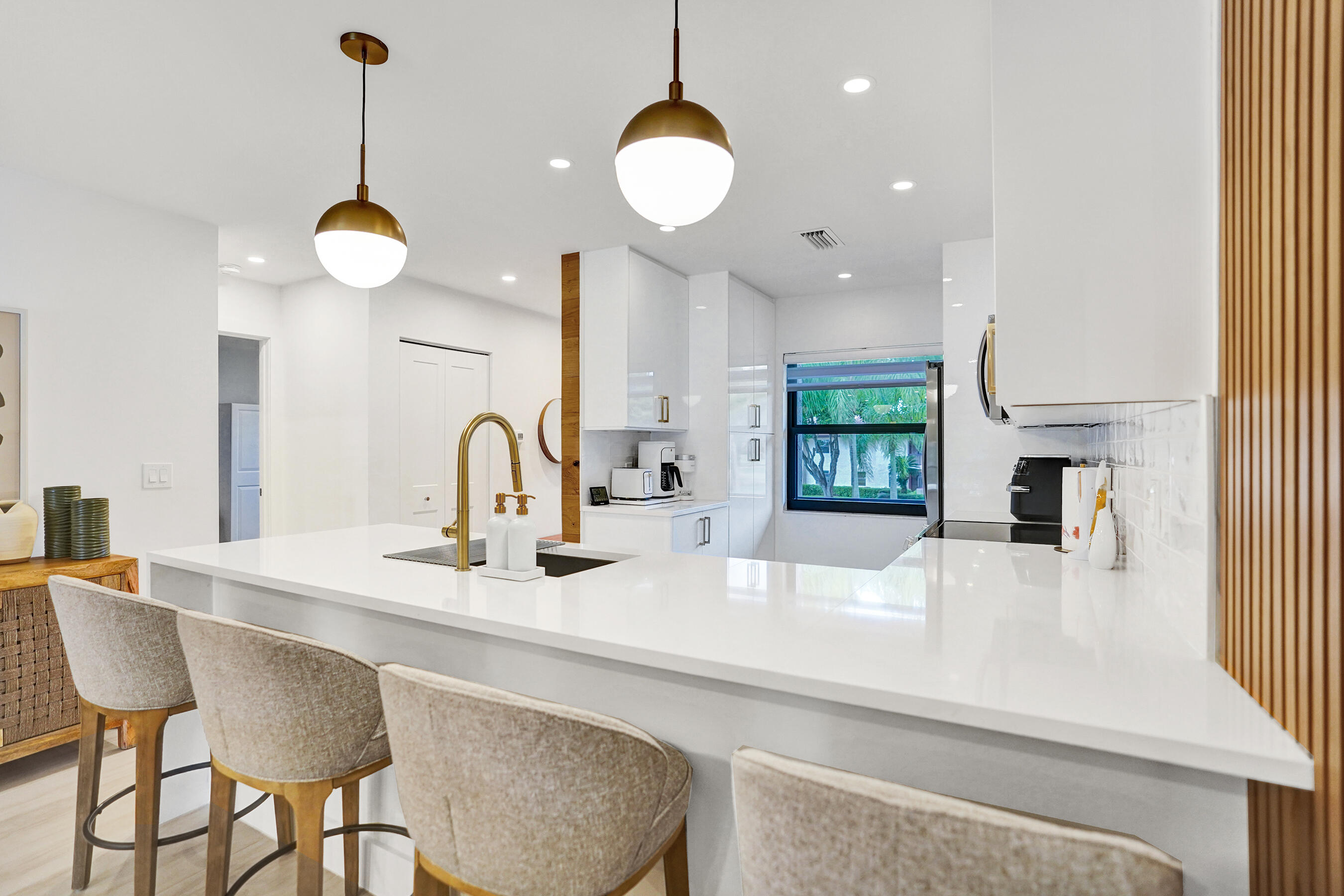 9293 Vista Del Lago, Unit 15F Boca Raton, FL 33428 - Photo 6 of 42 a kitchen with a table and chairs in it