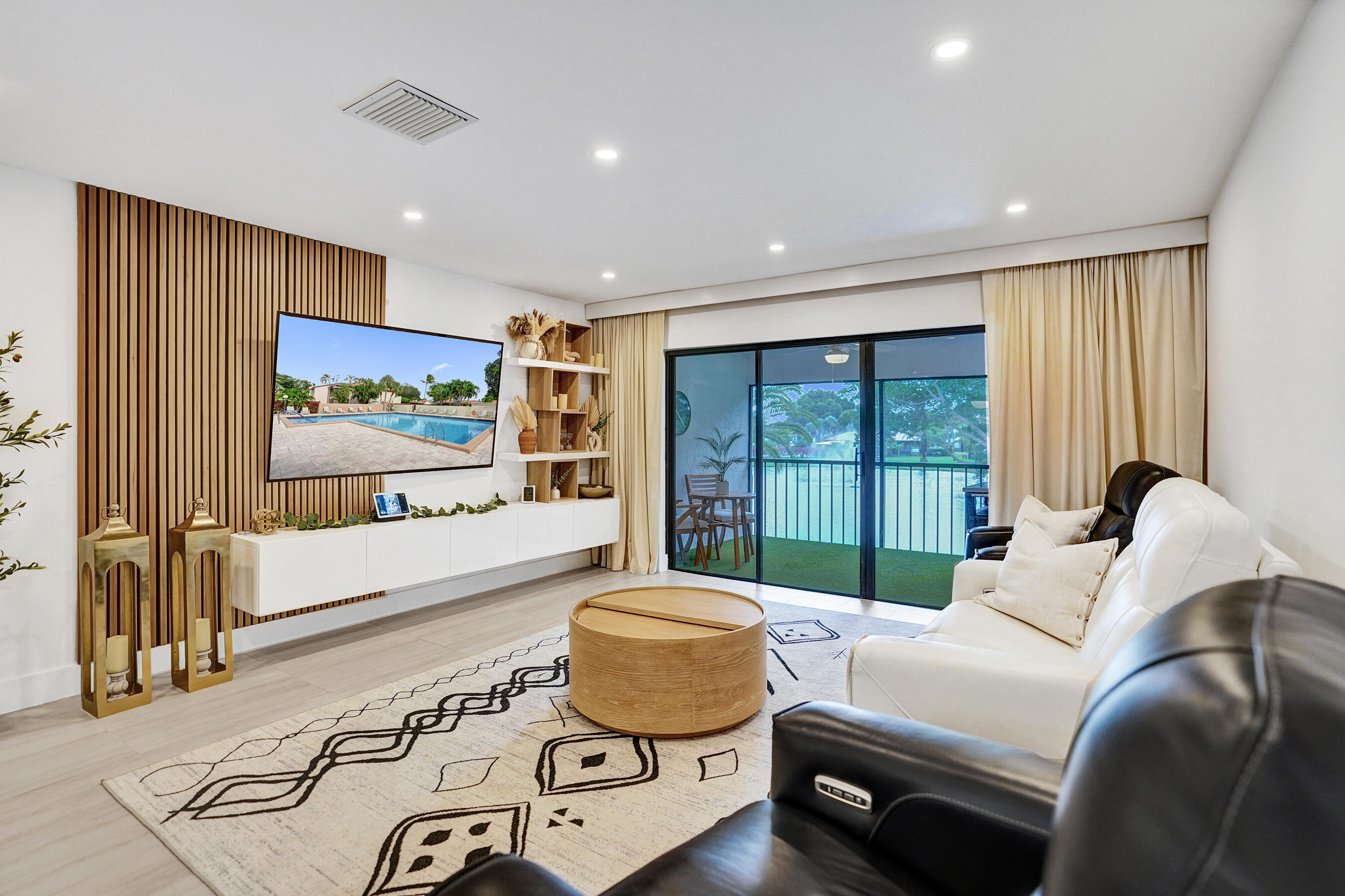 9293 Vista Del Lago, Unit 15F Boca Raton, FL 33428 - Photo 9 of 42 a living room with furniture and a large window