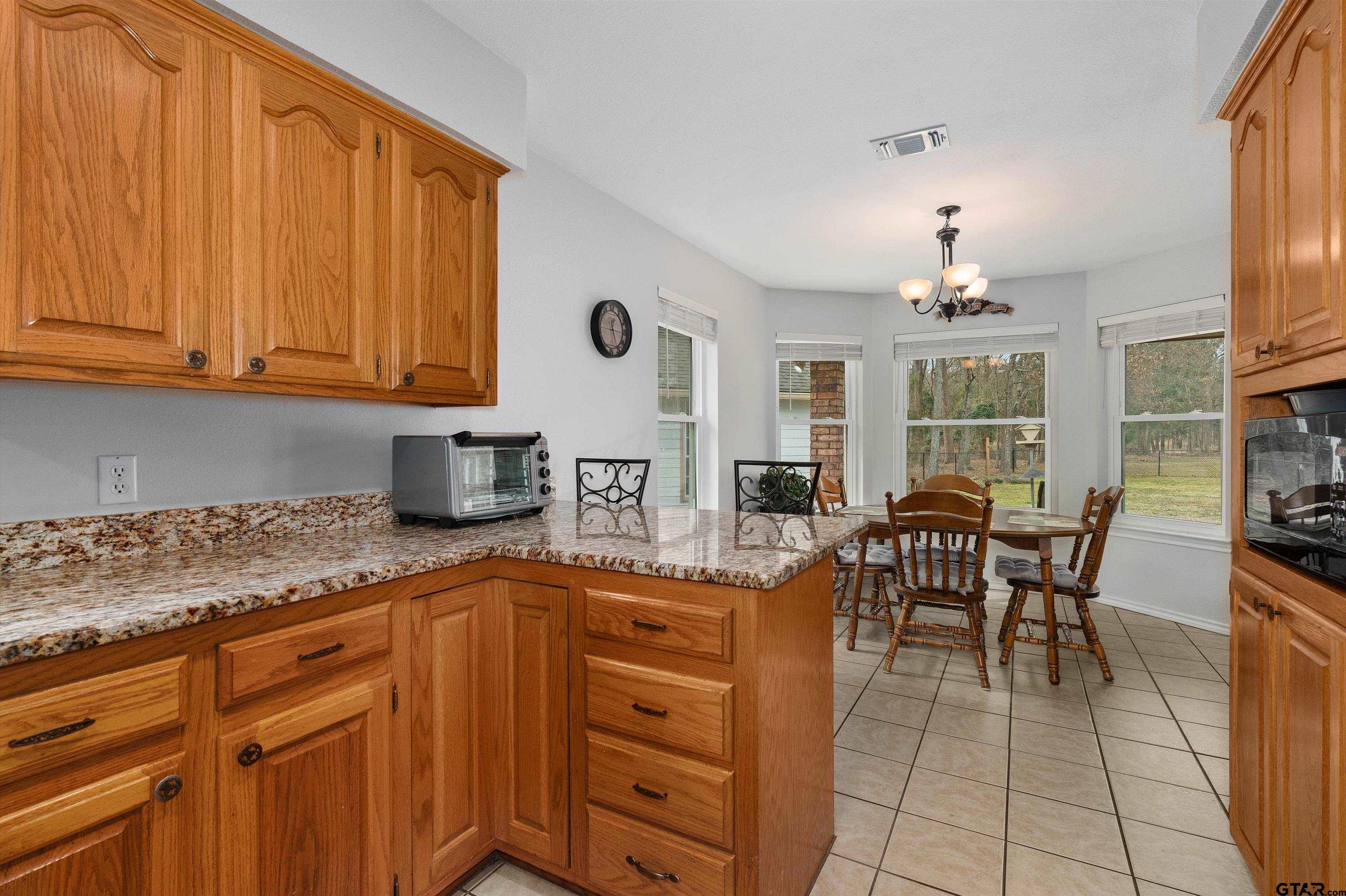 20 County Road 2938 South Pittsburg, TX 75686 - Photo 11 of 27 a kitchen with stainless steel appliances granite countertop a sink dishwasher and cabinets with wooden floor