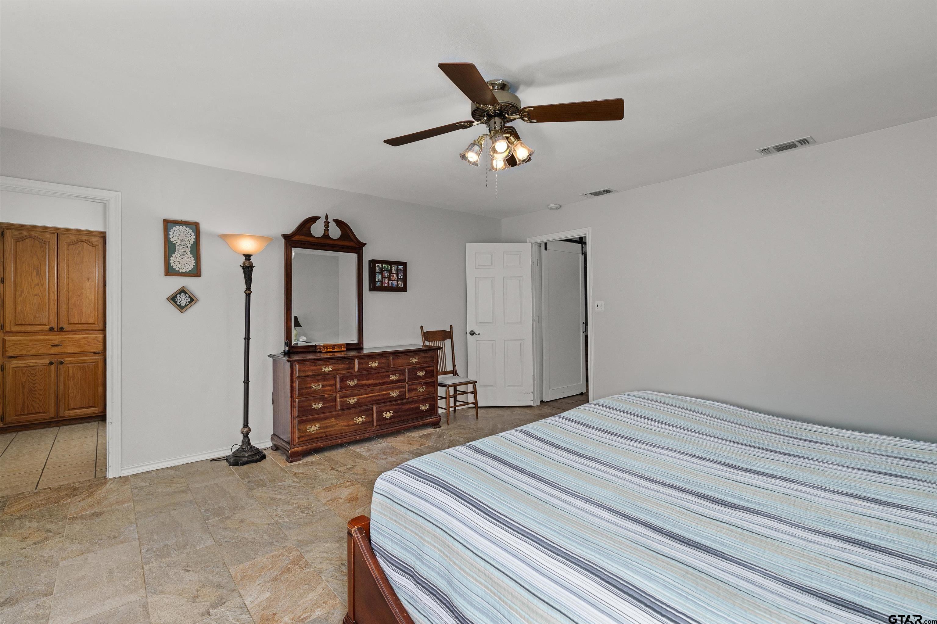 20 County Road 2938 South Pittsburg, TX 75686 - Photo 15 of 27 a bedroom with a bed dresser and a window