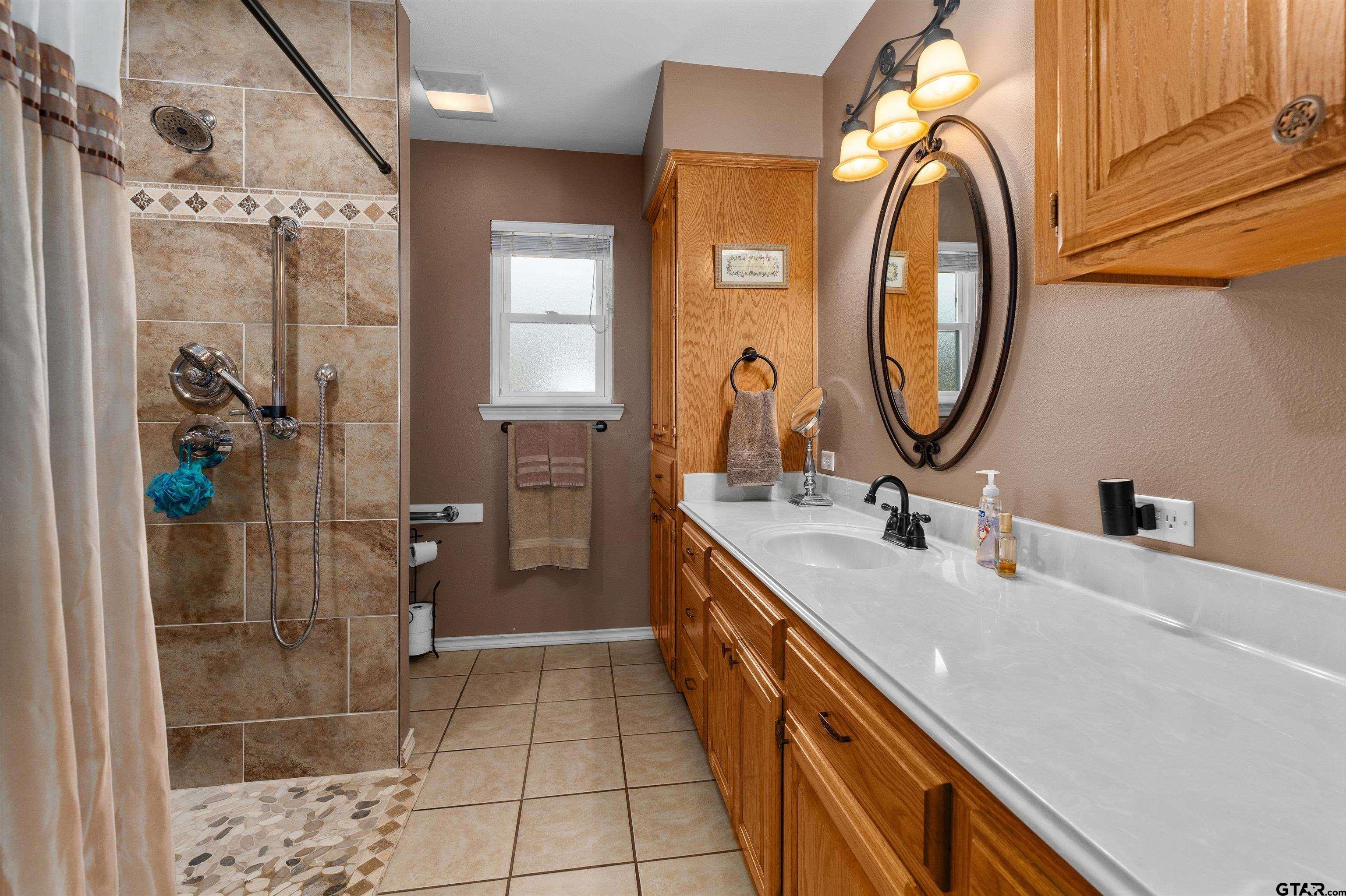20 County Road 2938 South Pittsburg, TX 75686 - Photo 19 of 27 a bathroom with a sink a toilet and a mirror