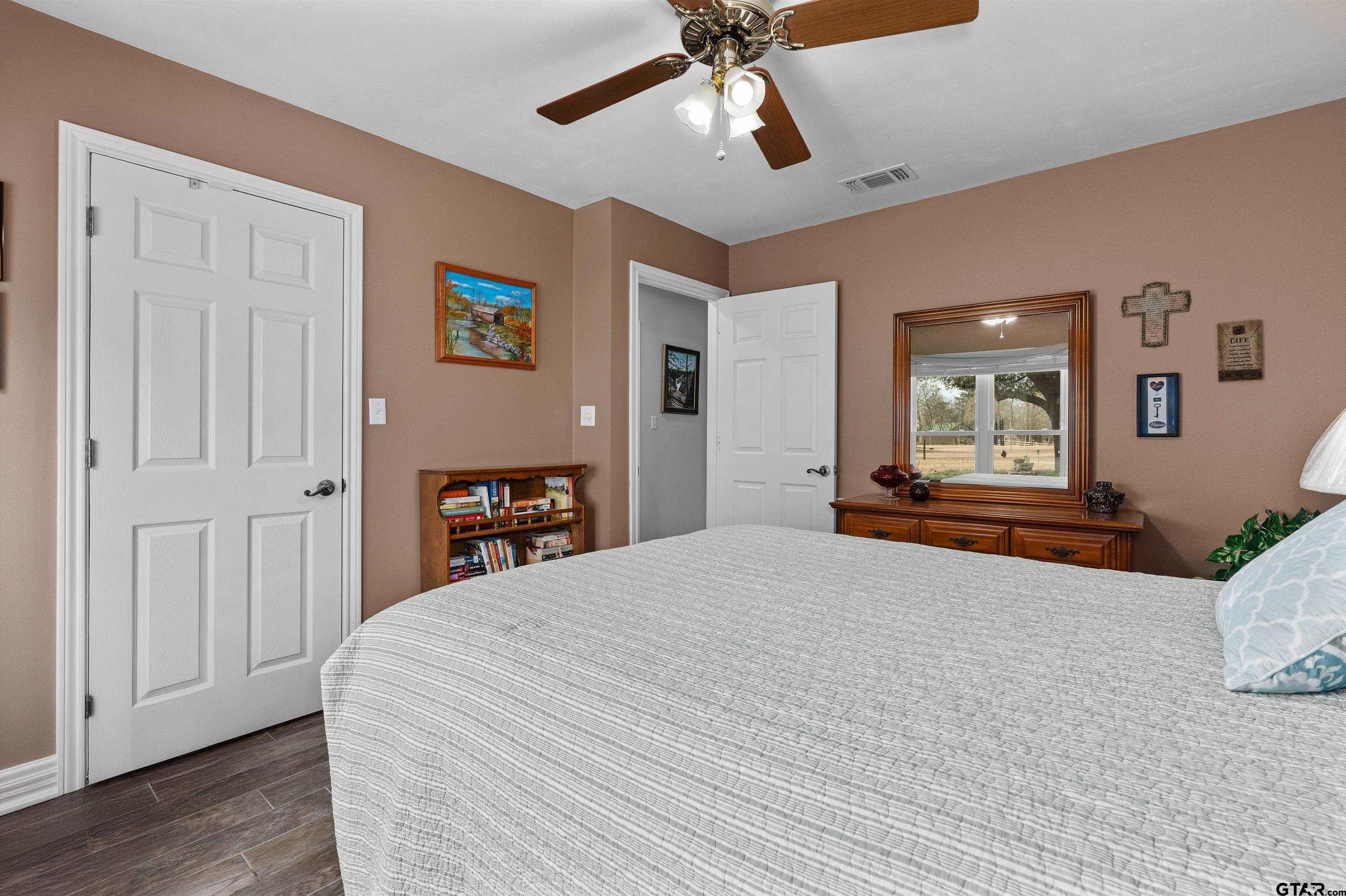 20 County Road 2938 South Pittsburg, TX 75686 - Photo 21 of 27 a bedroom with a bed and wooden floor