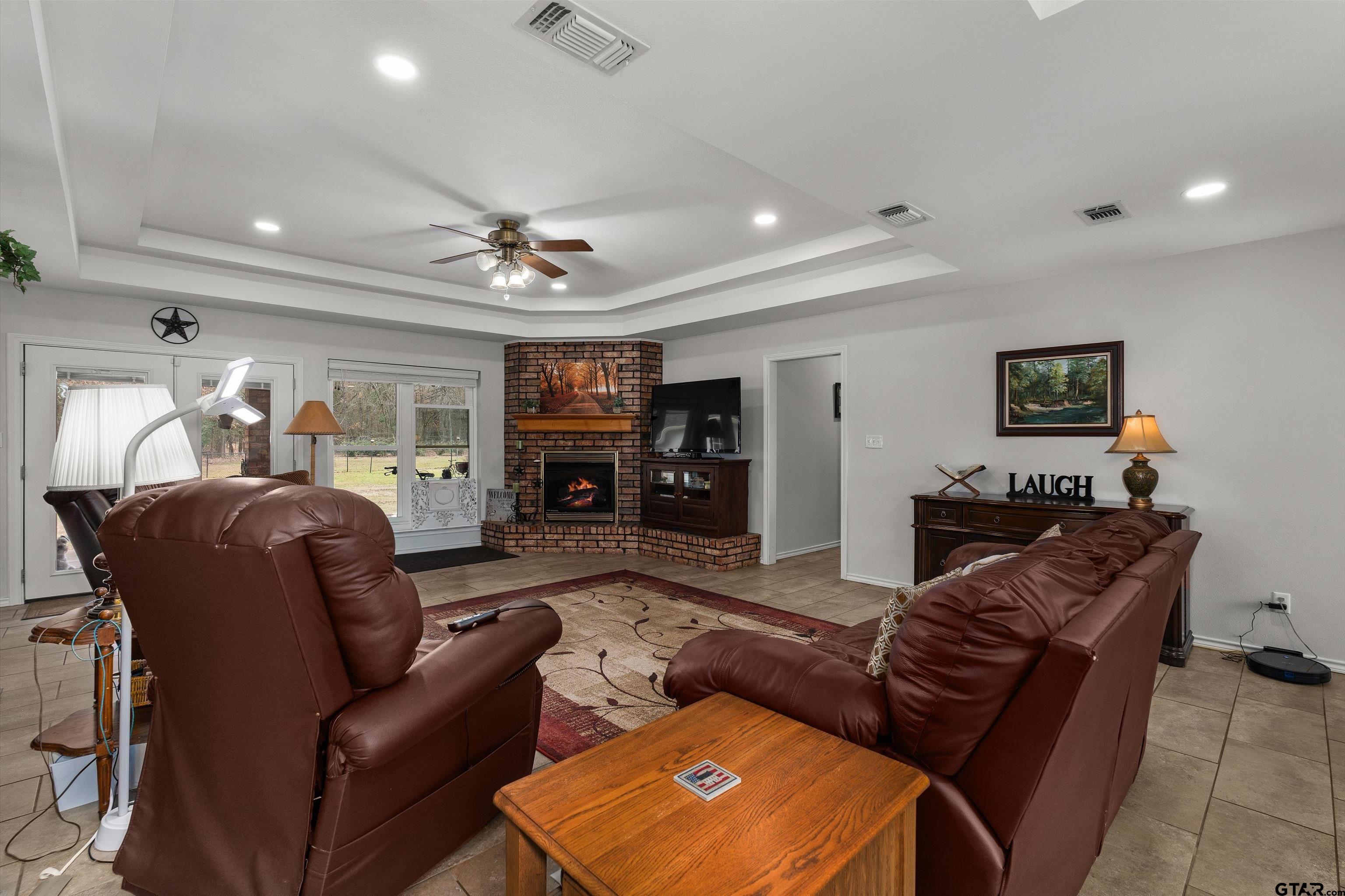 20 County Road 2938 South Pittsburg, TX 75686 - Photo 6 of 27 a living room with furniture a fireplace and a flat screen tv