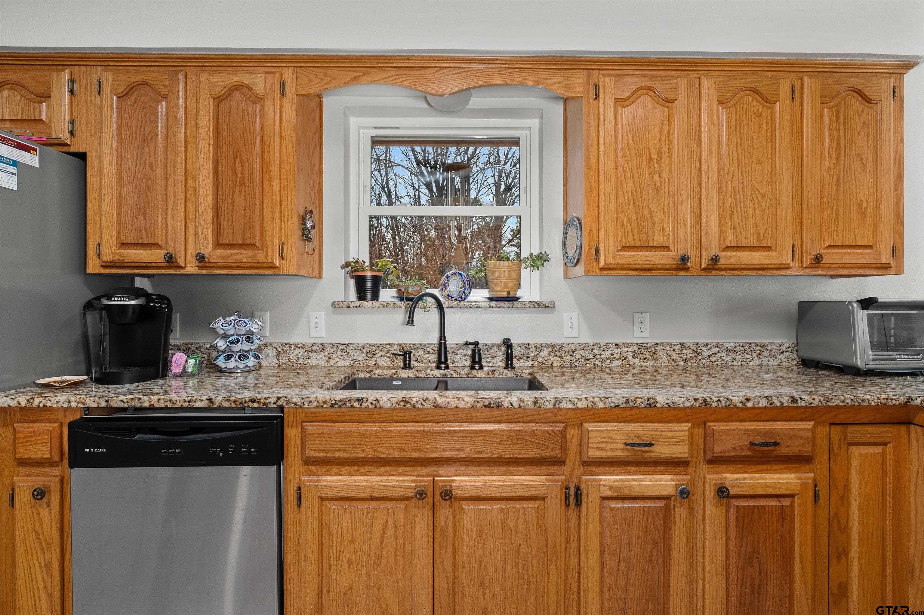 20 County Road 2938 South Pittsburg, TX 75686 - Photo 10 of 27 a kitchen with stainless steel appliances granite countertop a sink stove and cabinets