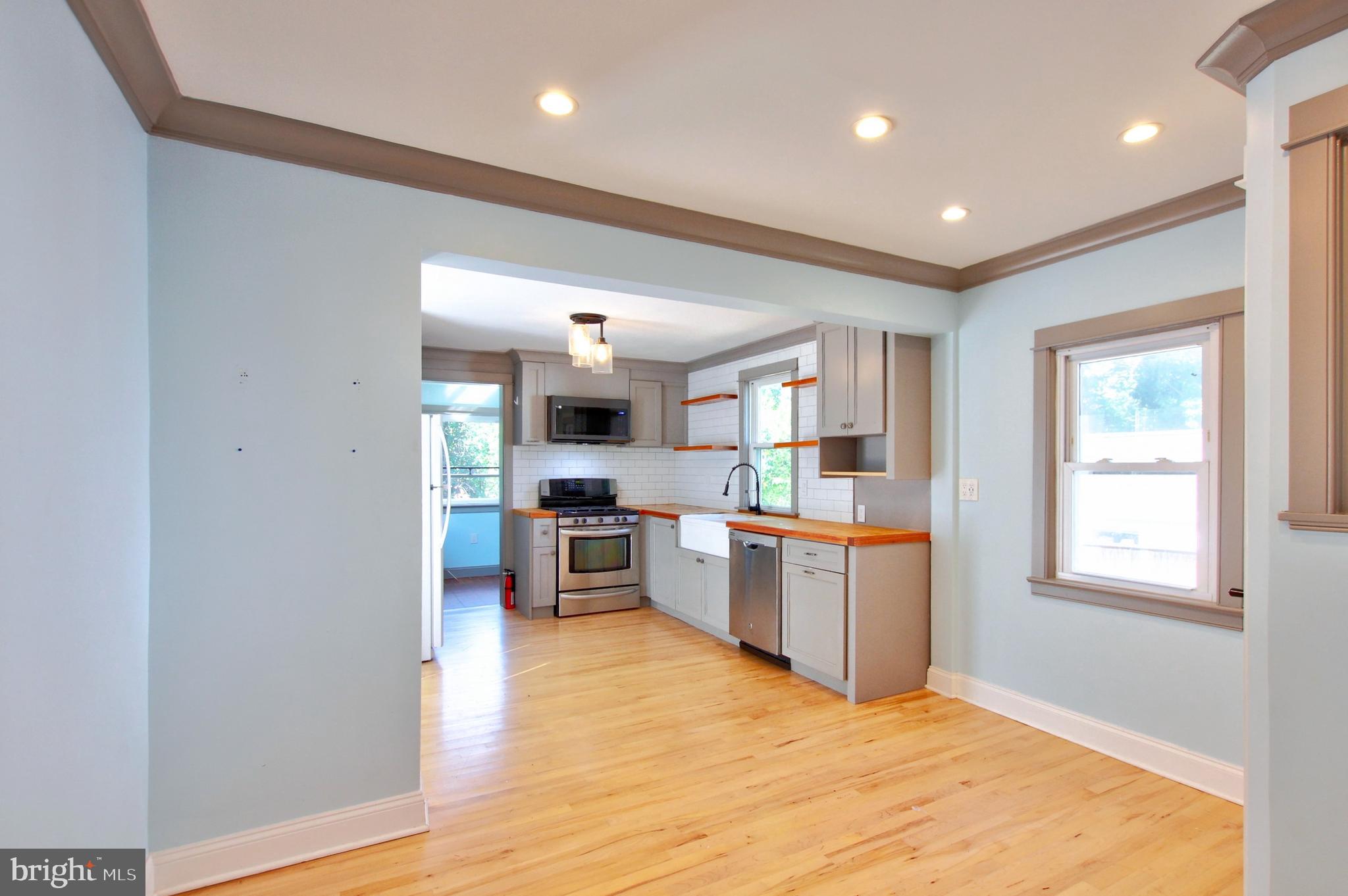 11808 Goodloe Road Silver Spring, MD 20906 - Photo 13 of 57 a large kitchen with a refrigerator and wooden floor