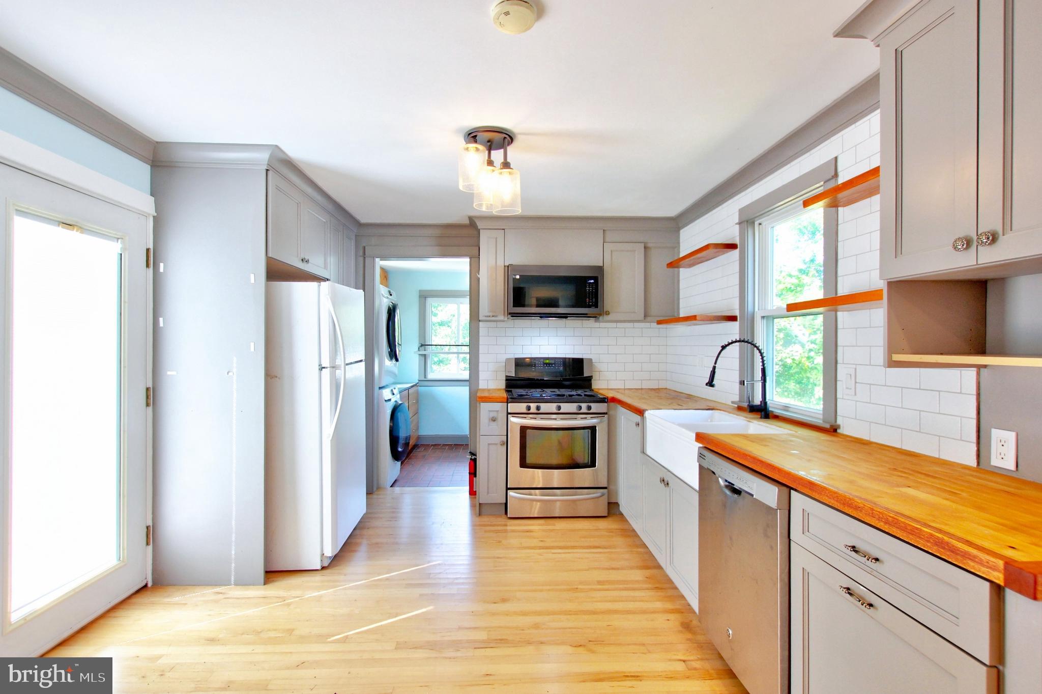 11808 Goodloe Road Silver Spring, MD 20906 - Photo 15 of 57 a kitchen with stainless steel appliances granite countertop a refrigerator a stove top oven a sink and dishwasher