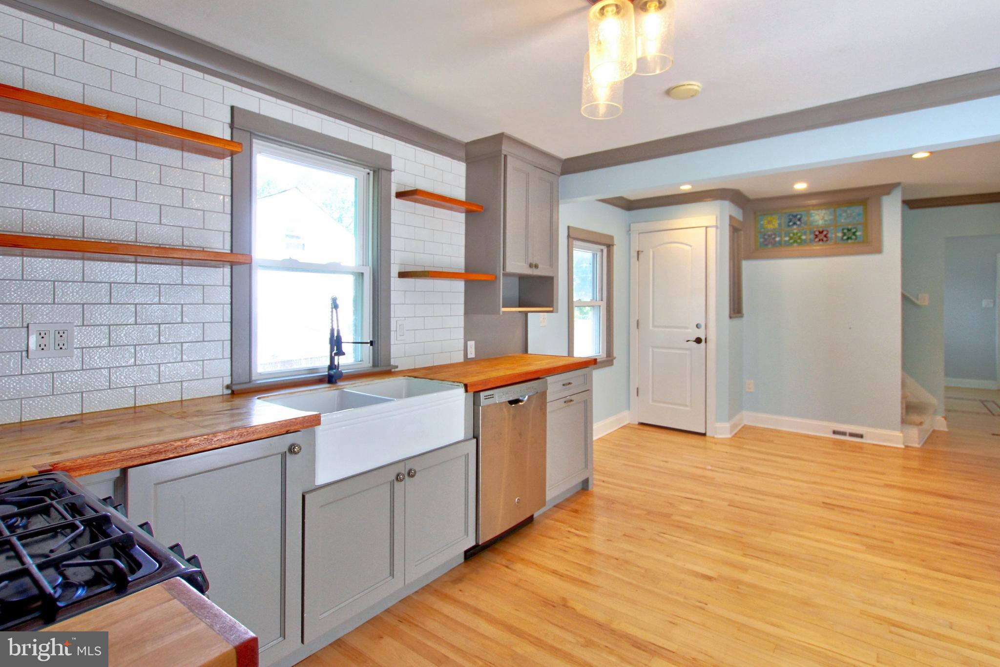 11808 Goodloe Road Silver Spring, MD 20906 - Photo 16 of 57 a large kitchen with stainless steel appliances granite countertop a sink and a wooden cabinets
