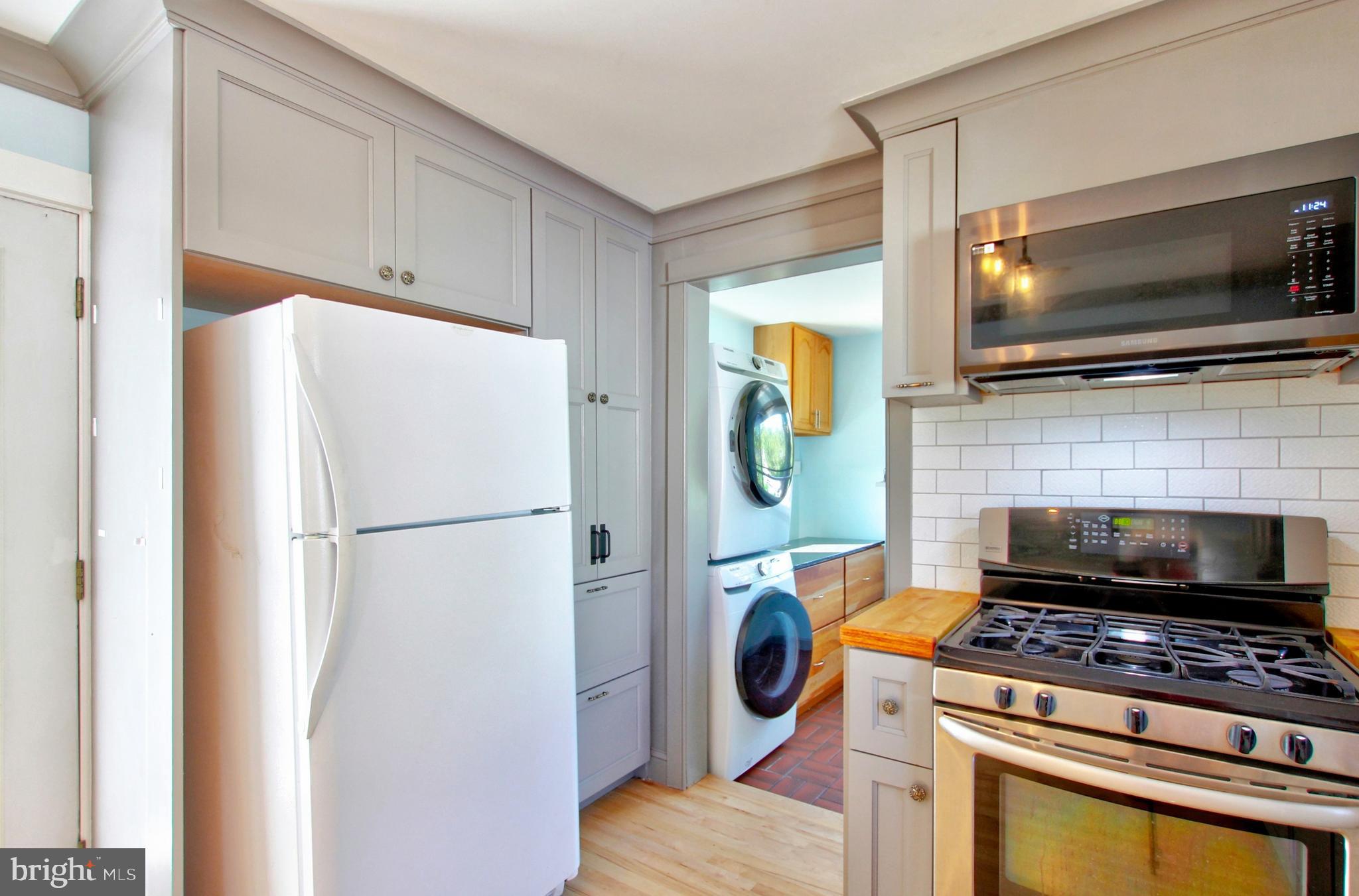 11808 Goodloe Road Silver Spring, MD 20906 - Photo 17 of 57 a kitchen with a refrigerator and a stove top oven