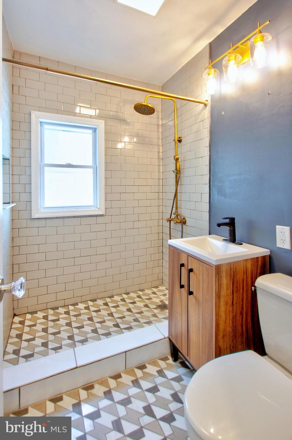 11808 Goodloe Road Silver Spring, MD 20906 - Photo 21 of 57 a bathroom with a sink a toilet a mirror and shower