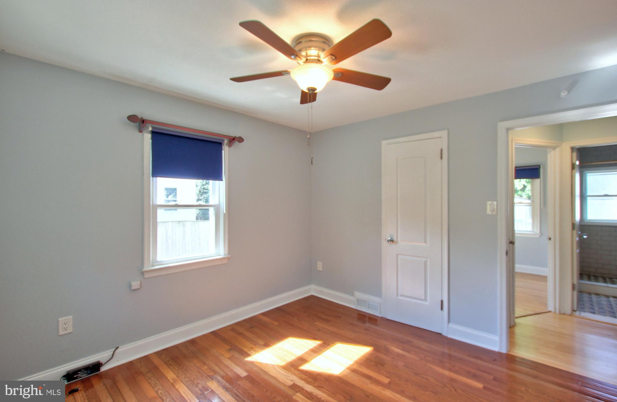 11808 Goodloe Road Silver Spring, MD 20906 - Photo 25 of 57 a view of an empty room with window and wooden floor