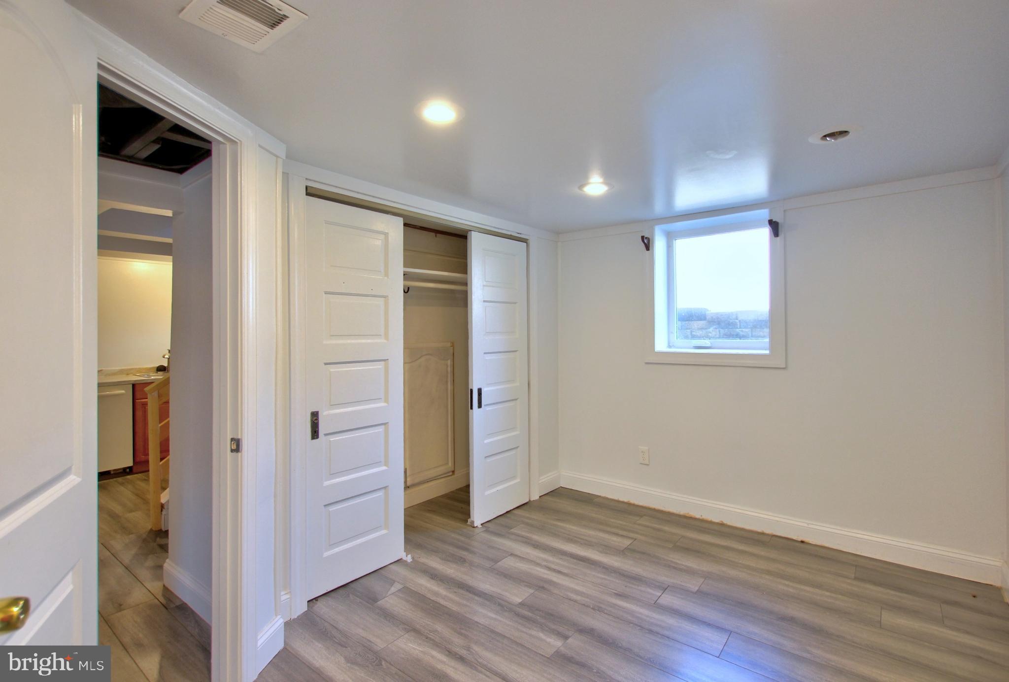 11808 Goodloe Road Silver Spring, MD 20906 - Photo 37 of 57 an empty room with wooden floor and closet