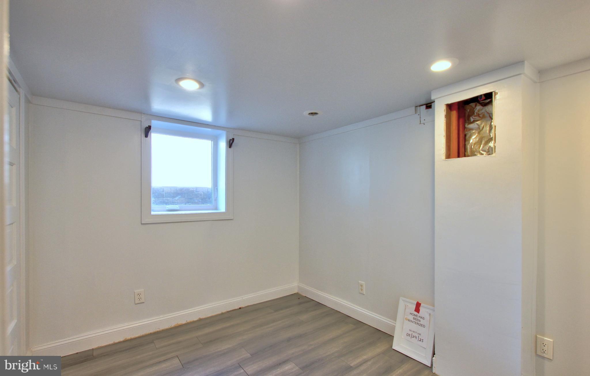 11808 Goodloe Road Silver Spring, MD 20906 - Photo 38 of 57 a view of an empty room with wooden floor and a window