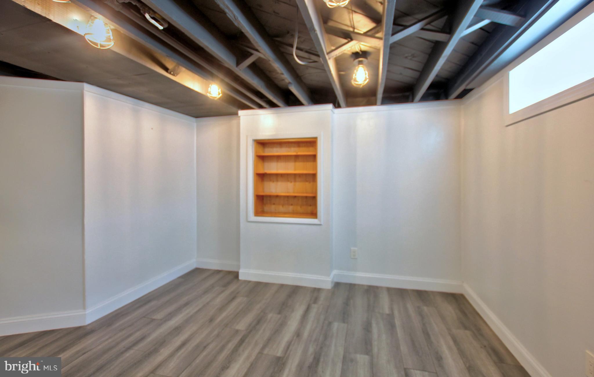 11808 Goodloe Road Silver Spring, MD 20906 - Photo 44 of 57 a view of an empty room with wooden floor and windows