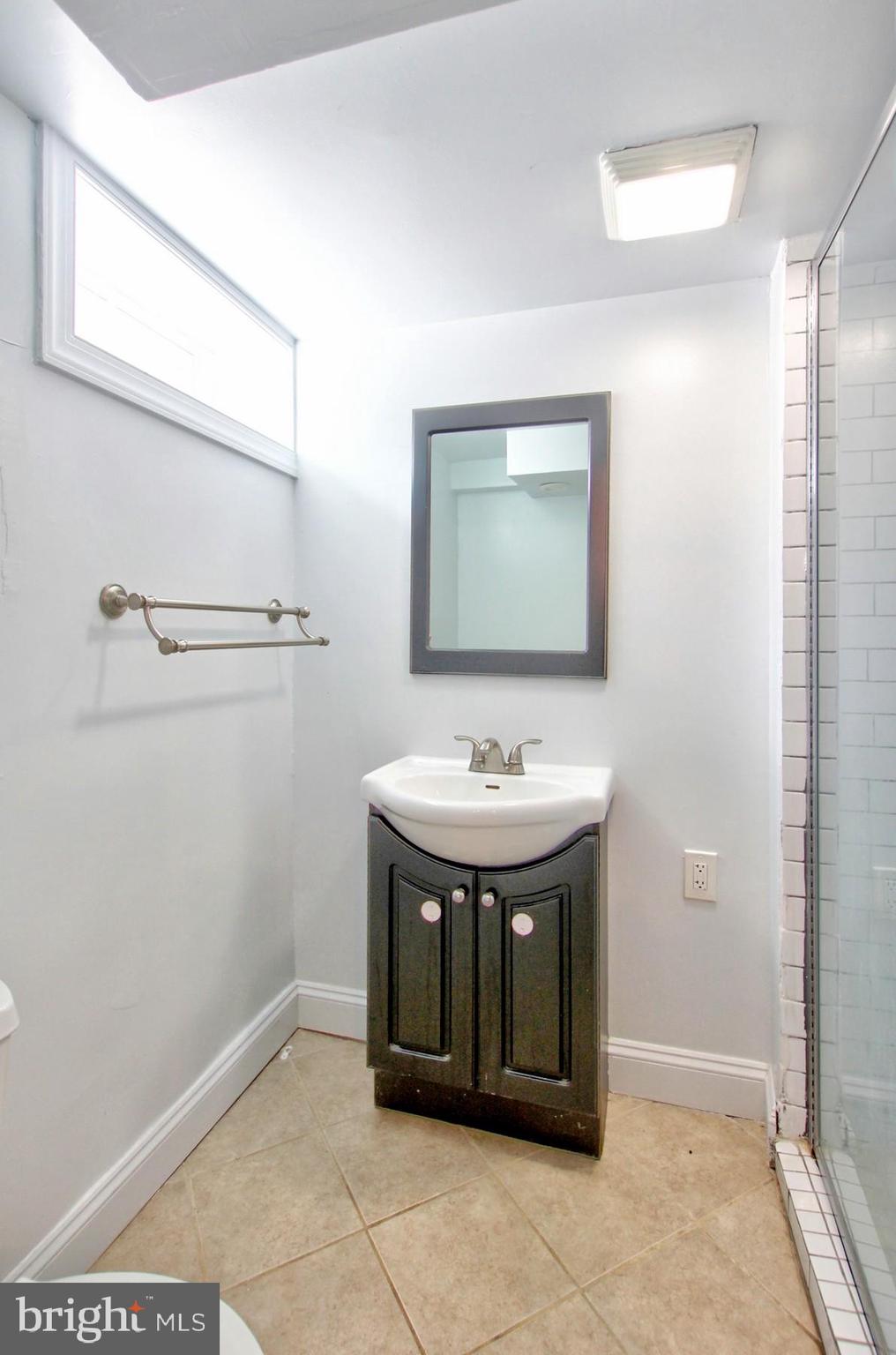 11808 Goodloe Road Silver Spring, MD 20906 - Photo 46 of 57 a bathroom with a sink and a mirror
