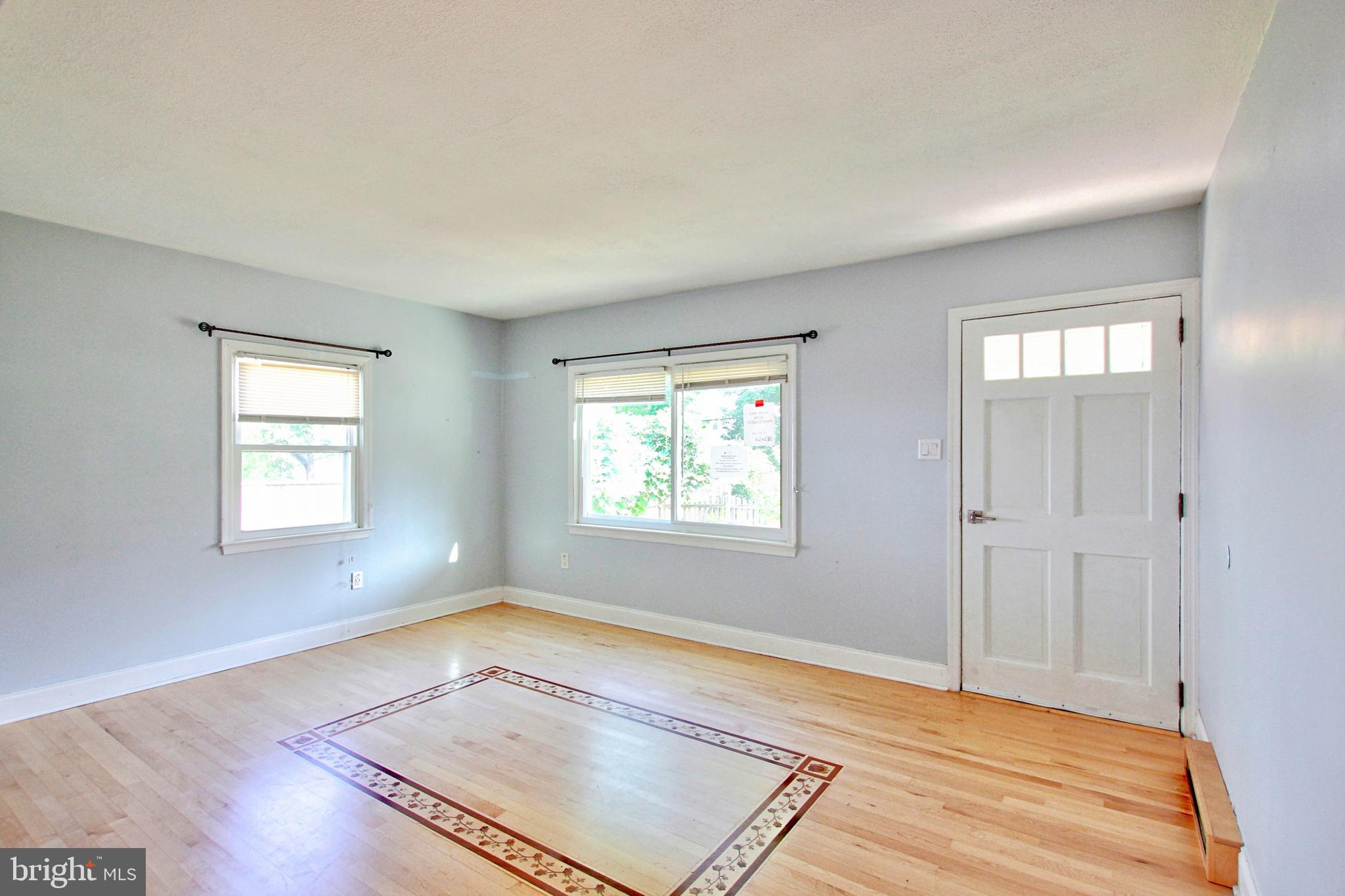11808 Goodloe Road Silver Spring, MD 20906 - Photo 6 of 57 a view of an empty room with wooden floor and a window