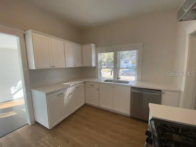 a kitchen with granite countertop white cabinets and white appliances