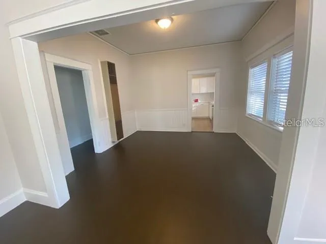 an empty room with windows and closet