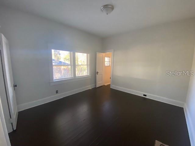 373 East Waldo Street Groveland, FL 34736 - Photo 21 of 23 an empty room with wooden floor and windows
