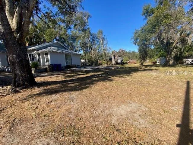 a view of a house with a yard covered with snow in the background