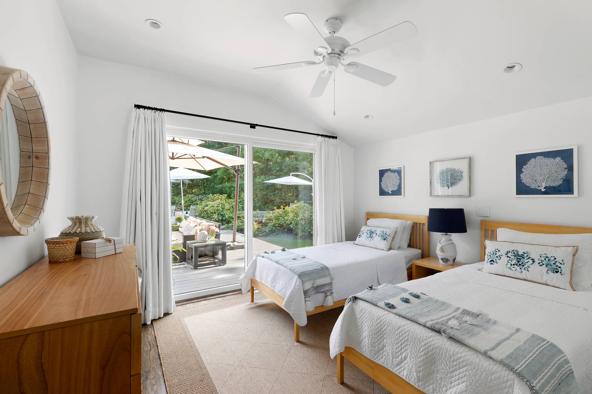 570 Rte 114 East Hampton, NY 11937 - Photo 15 of 30 a bedroom with two beds and a large mirror next to a window