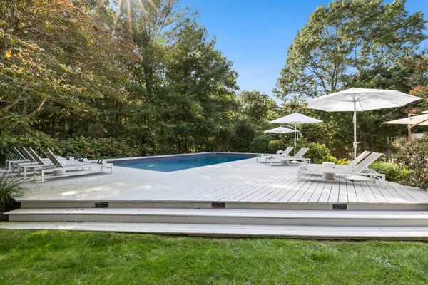 a view of backyard with wooden fence