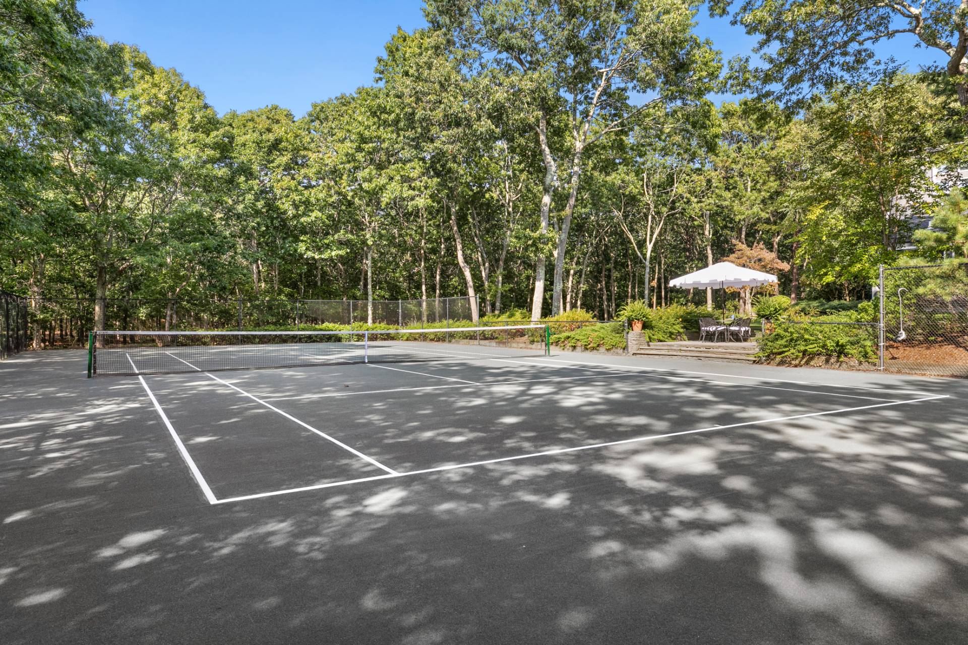 570 Rte 114 East Hampton, NY 11937 - Photo 24 of 30 a backyard of a house with table and chairs