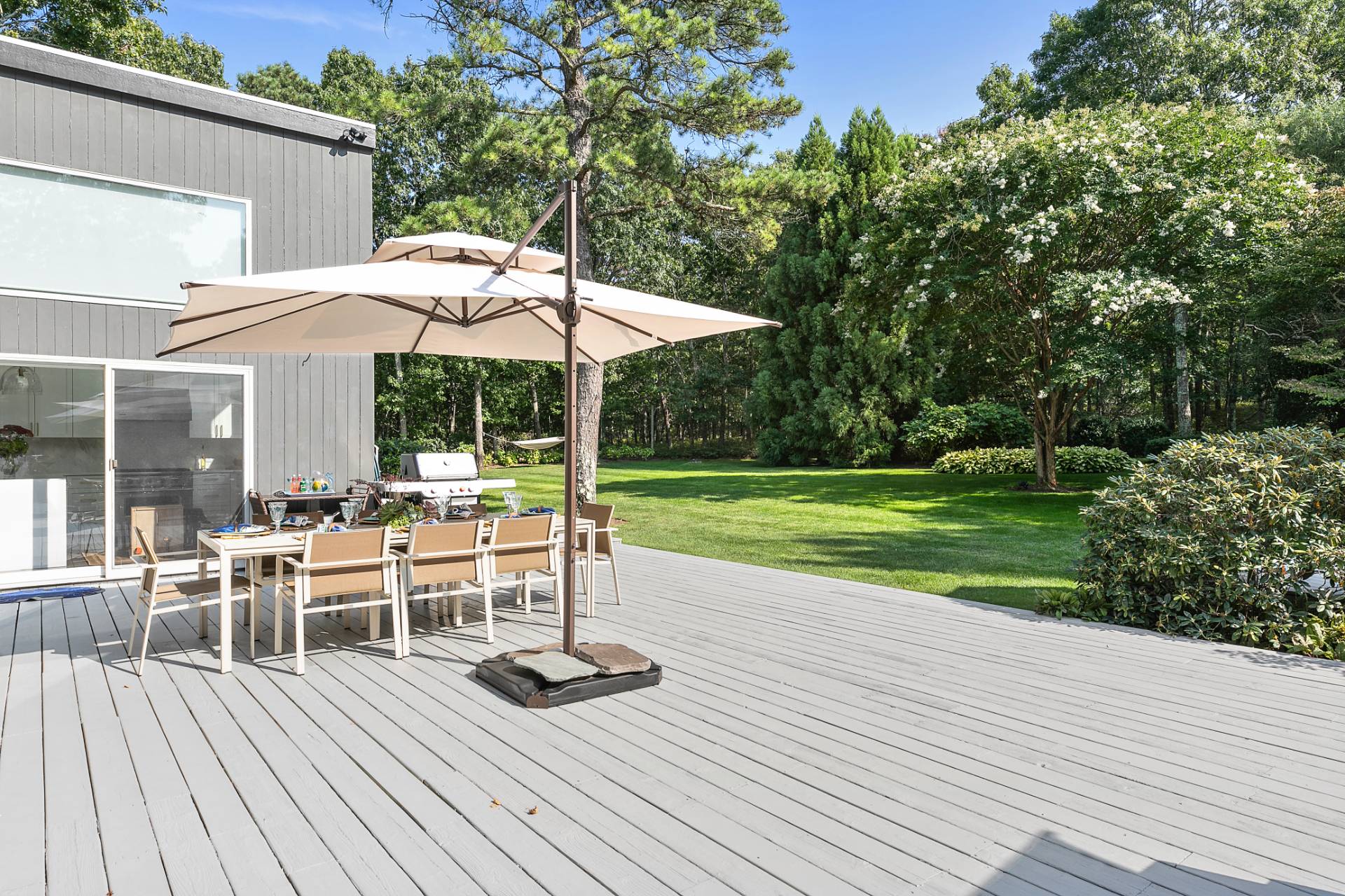 570 Rte 114 East Hampton, NY 11937 - Photo 28 of 30 a view of a patio with a table chairs and backyard