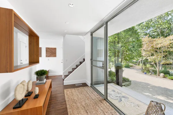 a view of entryway and hall with wooden floor