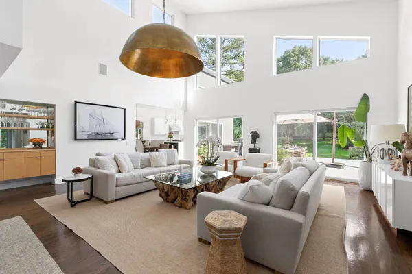 a living room with furniture a fireplace and a large window