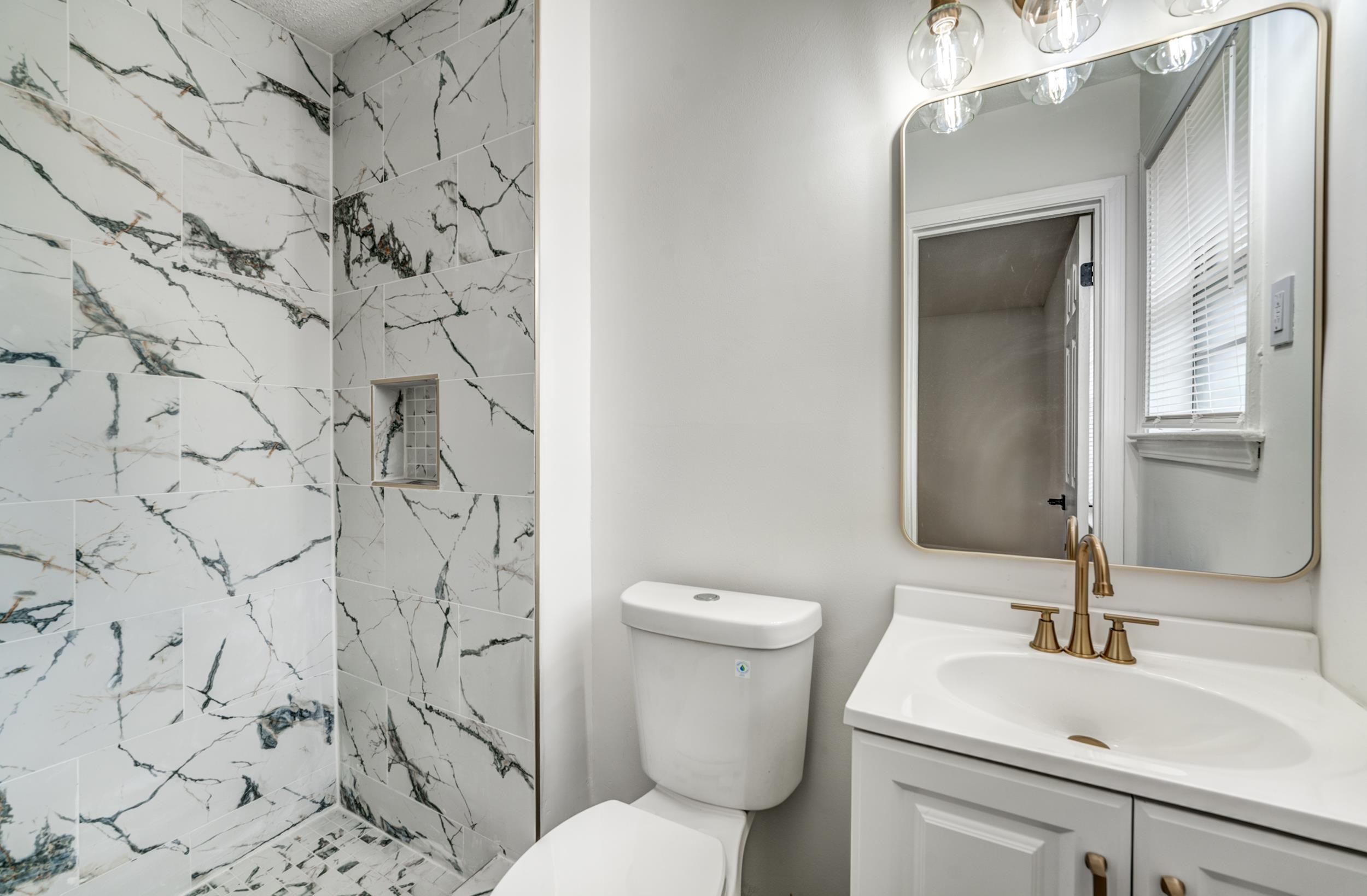 5156 Windcrest Road Memphis, TN 38116 - Photo 11 of 24 Full bathroom with vanity and a marble finish shower