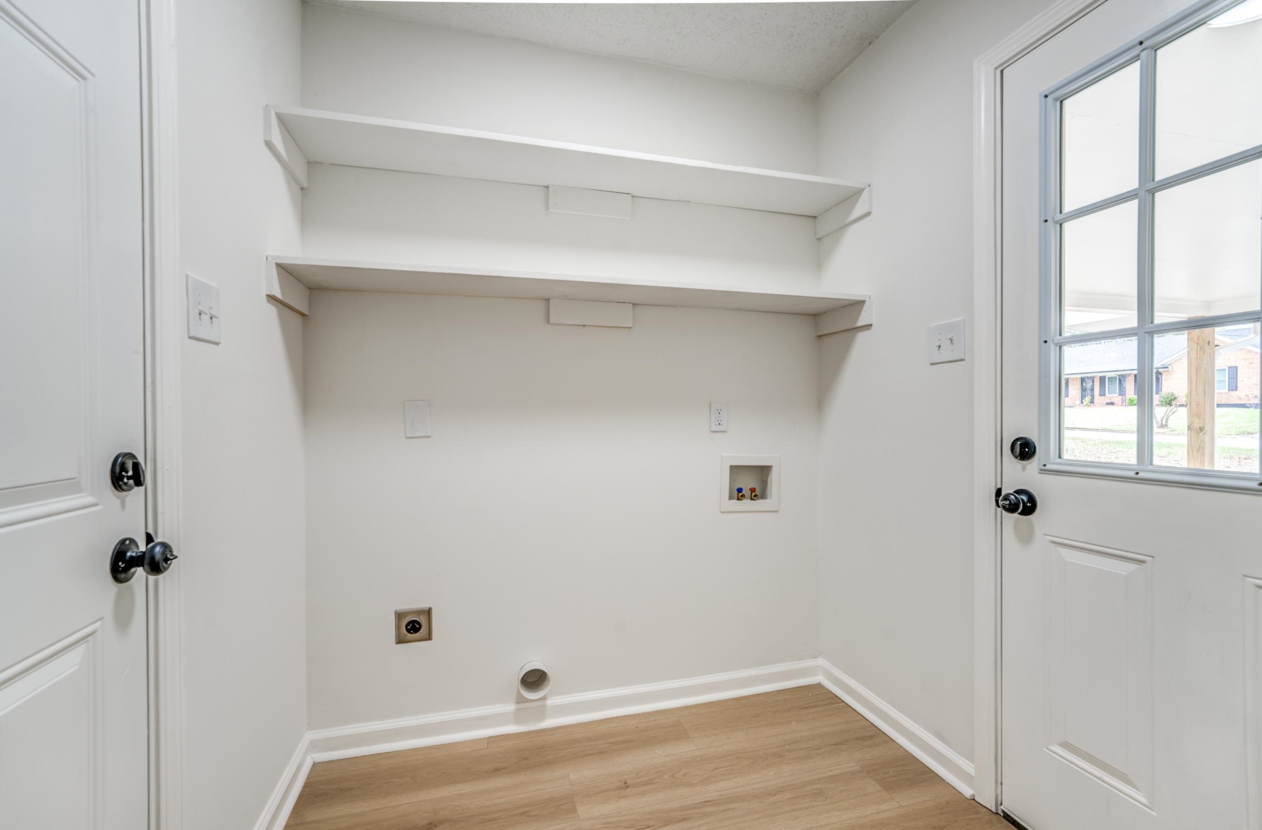 5156 Windcrest Road Memphis, TN 38116 - Photo 22 of 24 Laundry area featuring light wood-style flooring, electric dryer hookup, and hookup for a washing machine
