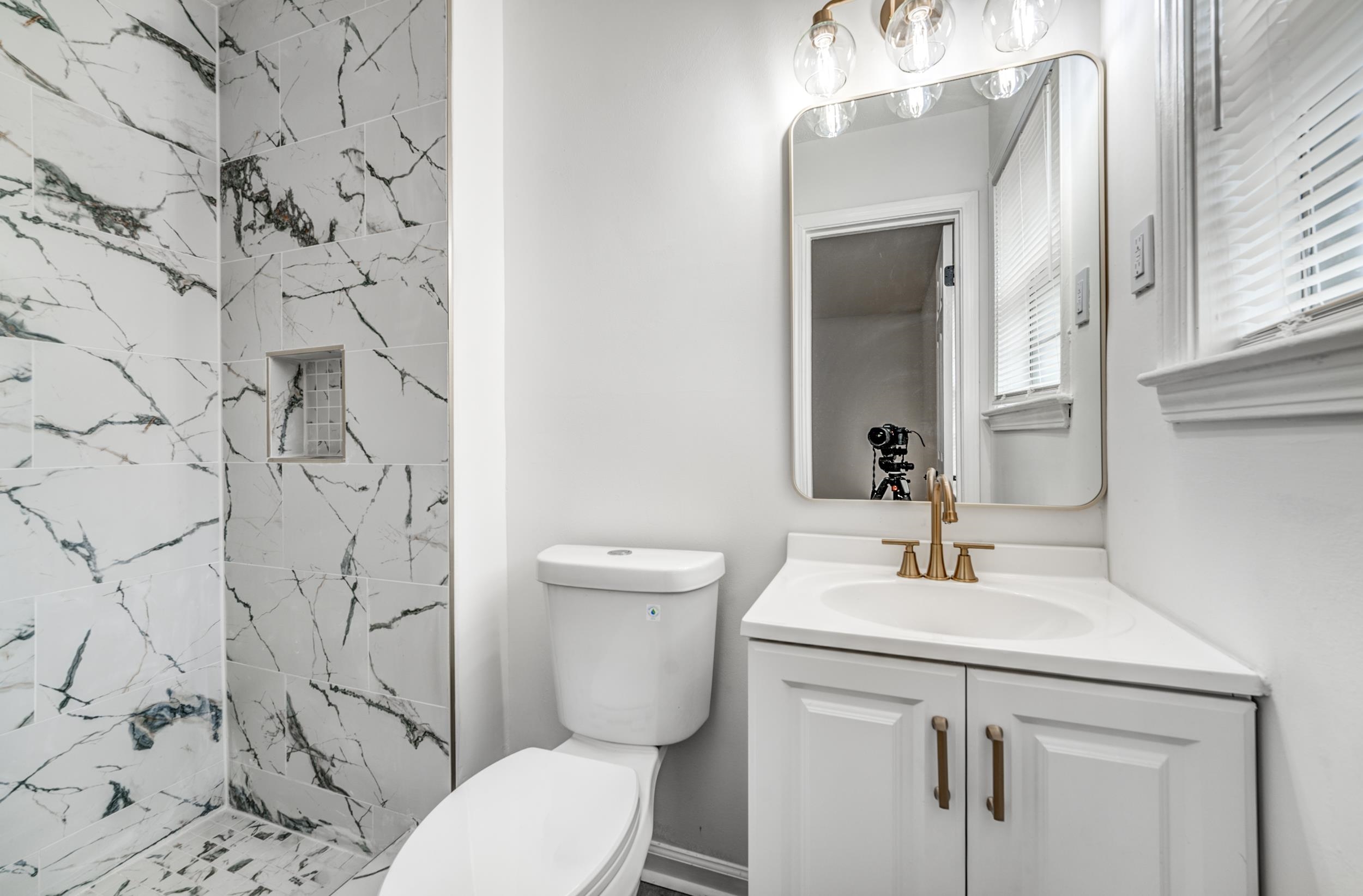 5156 Windcrest Road Memphis, TN 38116 - Photo 9 of 24 Bathroom featuring vanity and a marble finish shower
