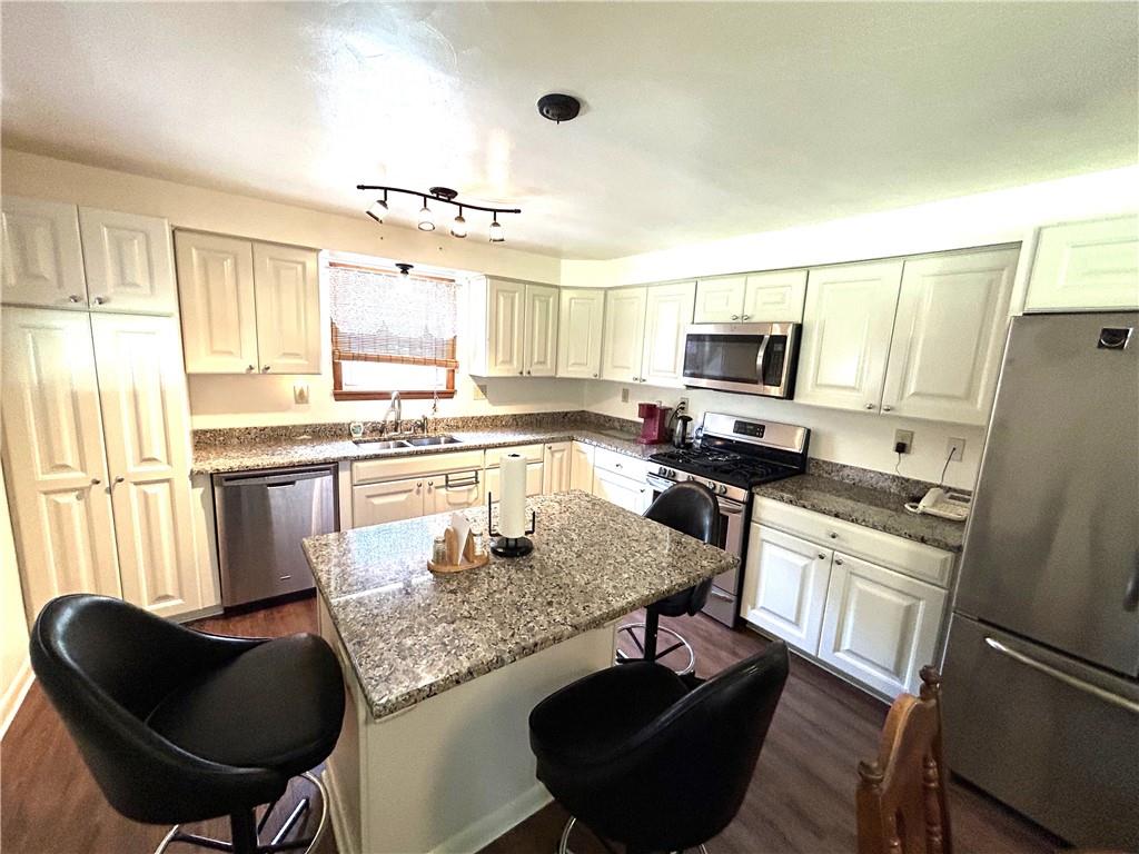 111 Iseman Road Freeport, PA 16229 - Photo 19 of 50 a kitchen with kitchen island a counter space dining table and stainless steel appliances