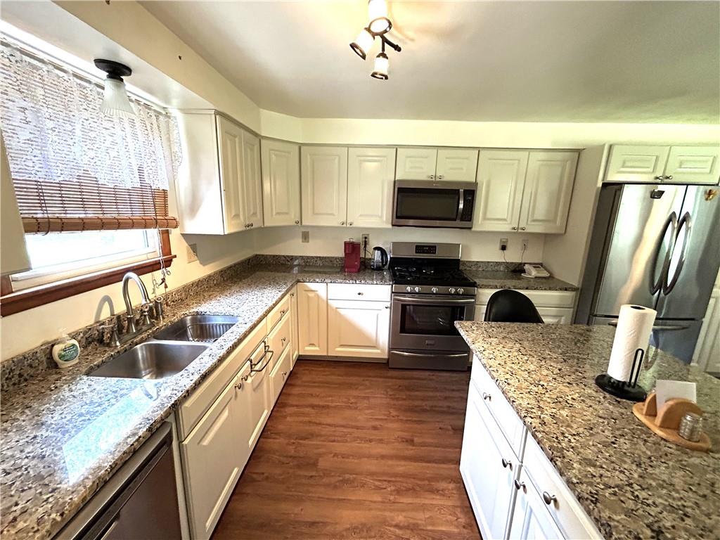 111 Iseman Road Freeport, PA 16229 - Photo 21 of 50 a view of a kitchen with kitchen island granite countertop a large window and stainless steel appliances