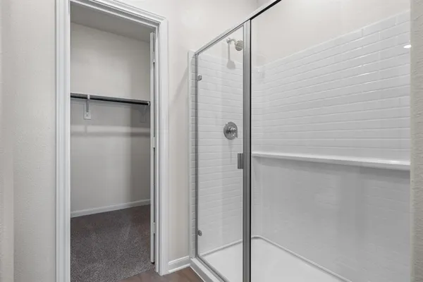 a bathroom with a glass shower door