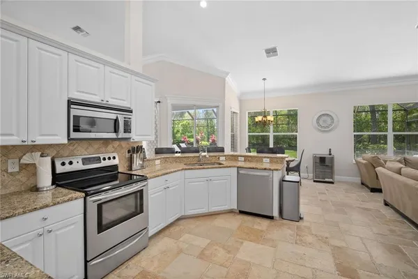 a kitchen with a stove a sink and a microwave